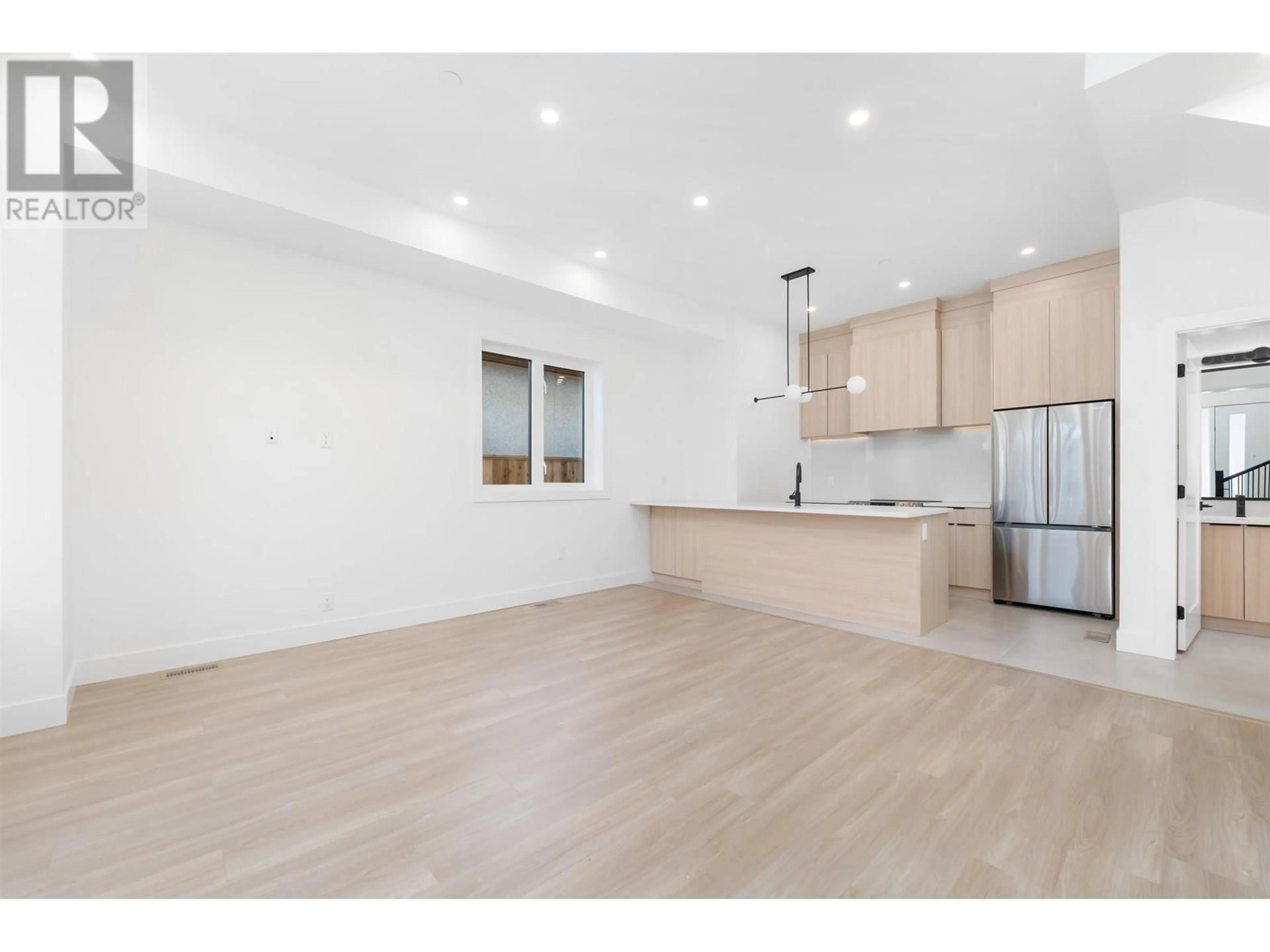 Open concept kitchen, wood/laminate floor for 4016 RUPERT STREET, Vancouver British Columbia V5R2H3