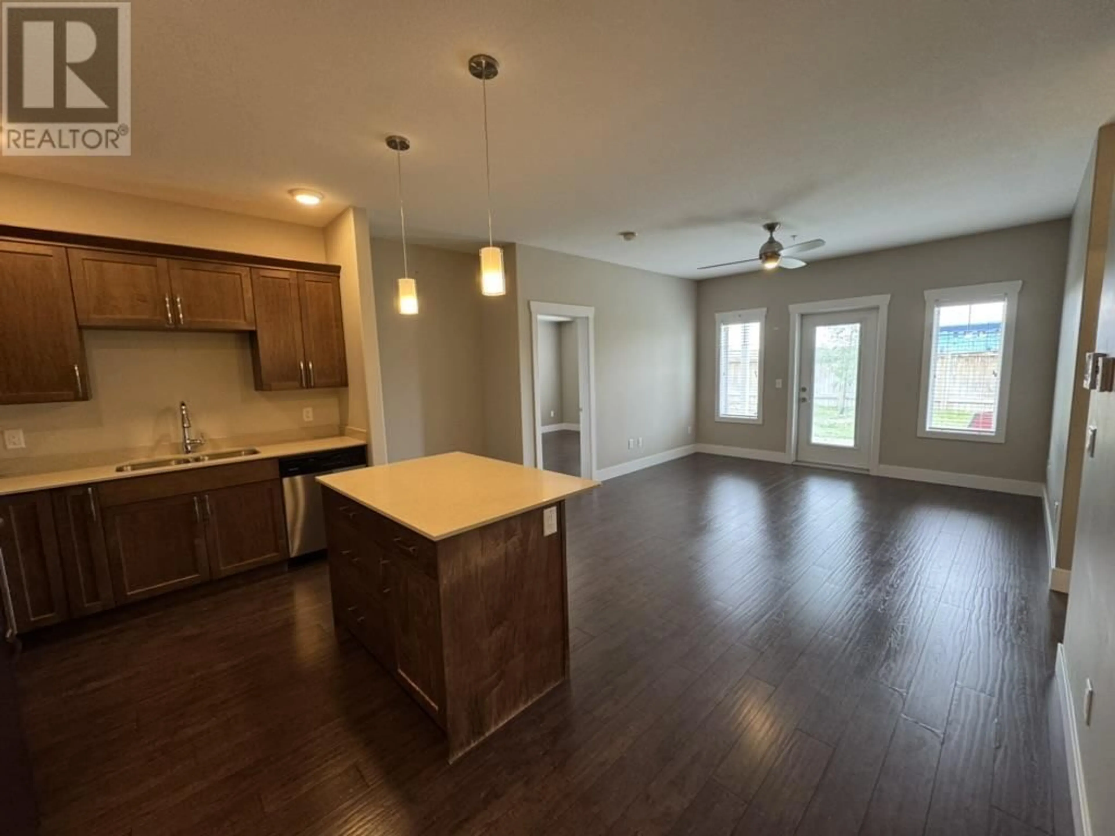 Open concept kitchen, wood/laminate floor for 106 - 11205 105 AVENUE, Fort St. John British Columbia V1J0L3