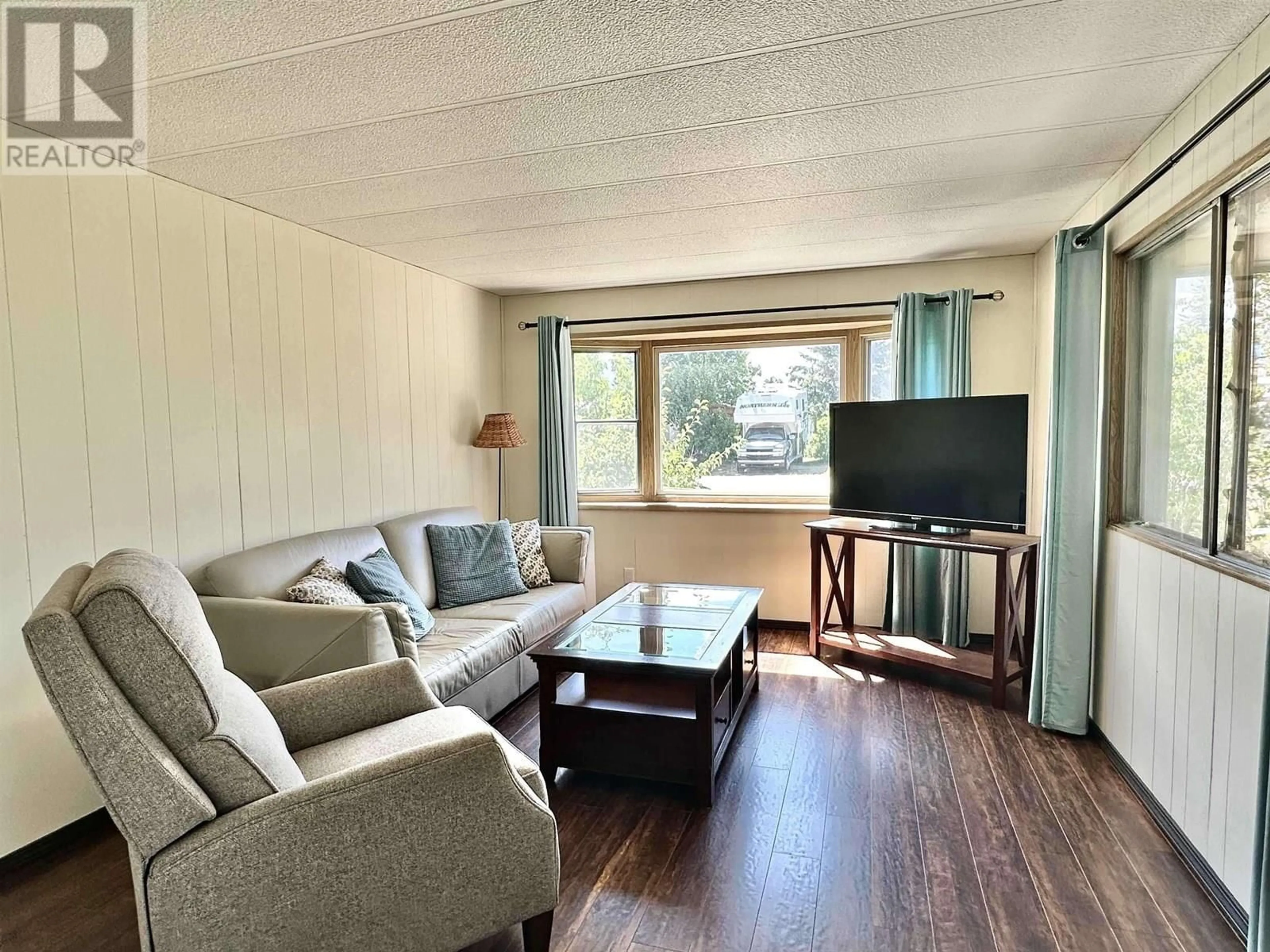 Living room with furniture, wood/laminate floor for 1080 4TH AVENUE, Valemount British Columbia V0E2Z0
