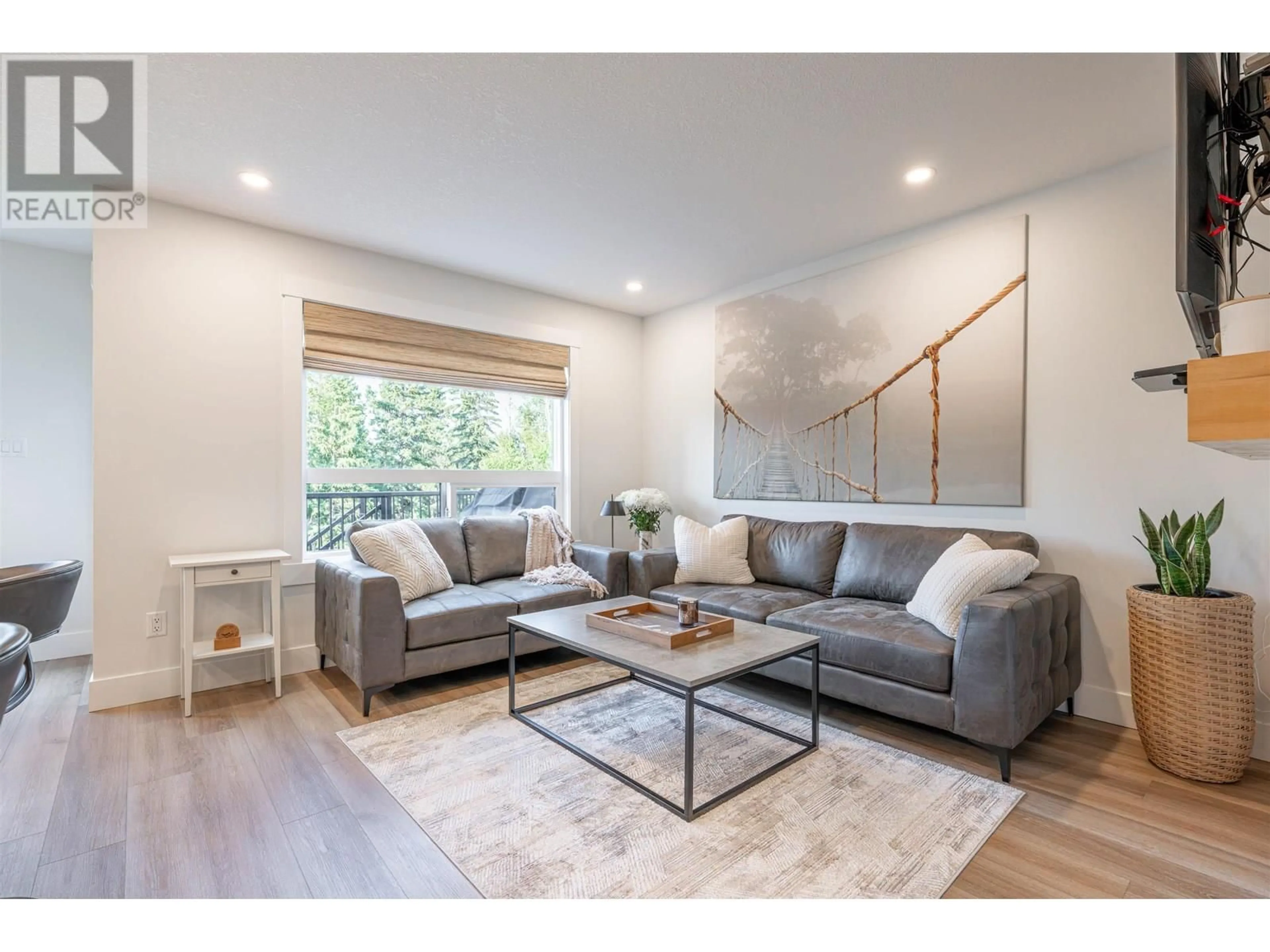 Living room with furniture, wood/laminate floor for 114 - 6664 WESTMOUNT DRIVE, Prince George British Columbia V2N6R3