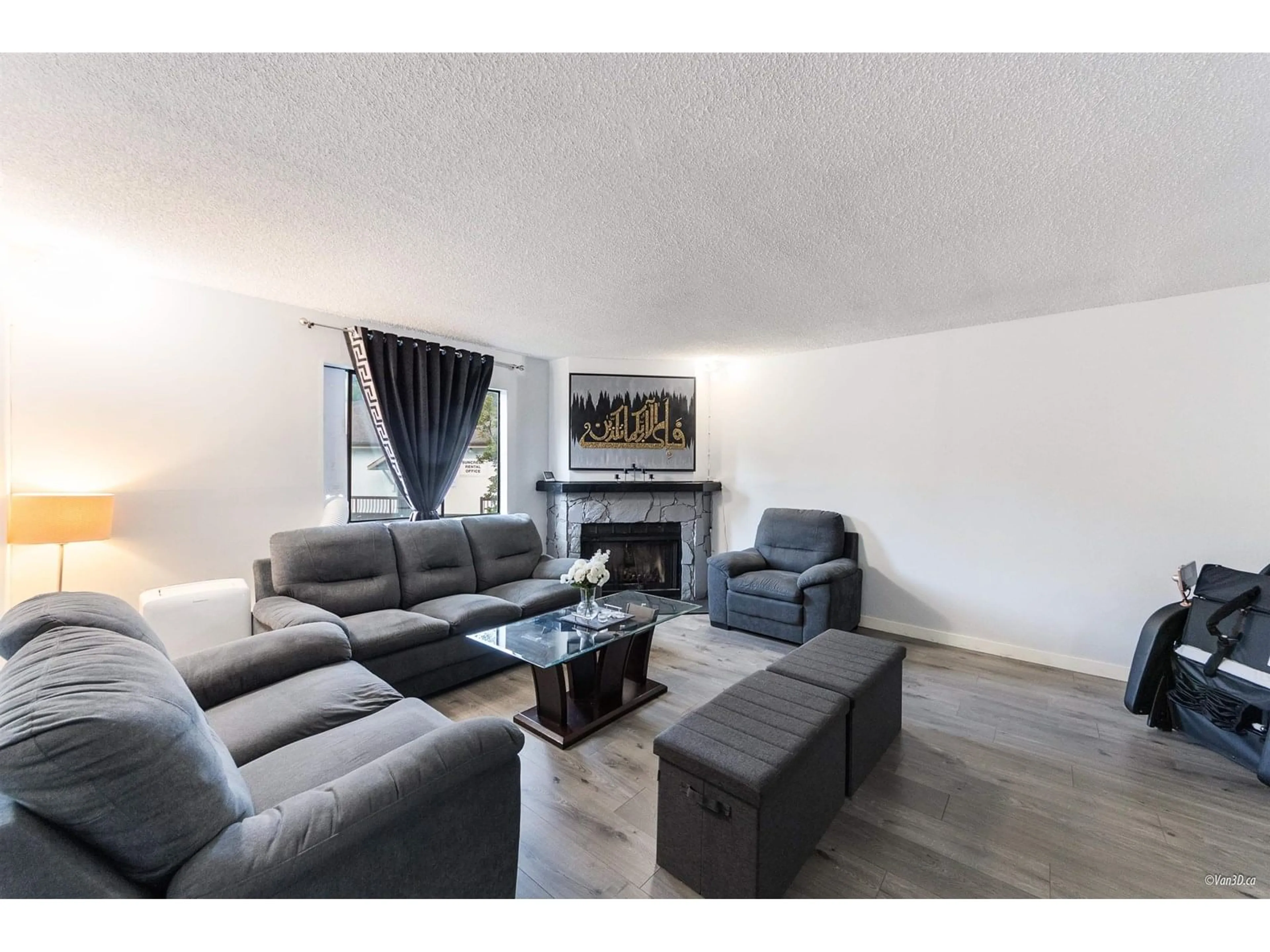 Living room with furniture, wood/laminate floor for 203 - 7131 133A, Surrey British Columbia V2W8A1