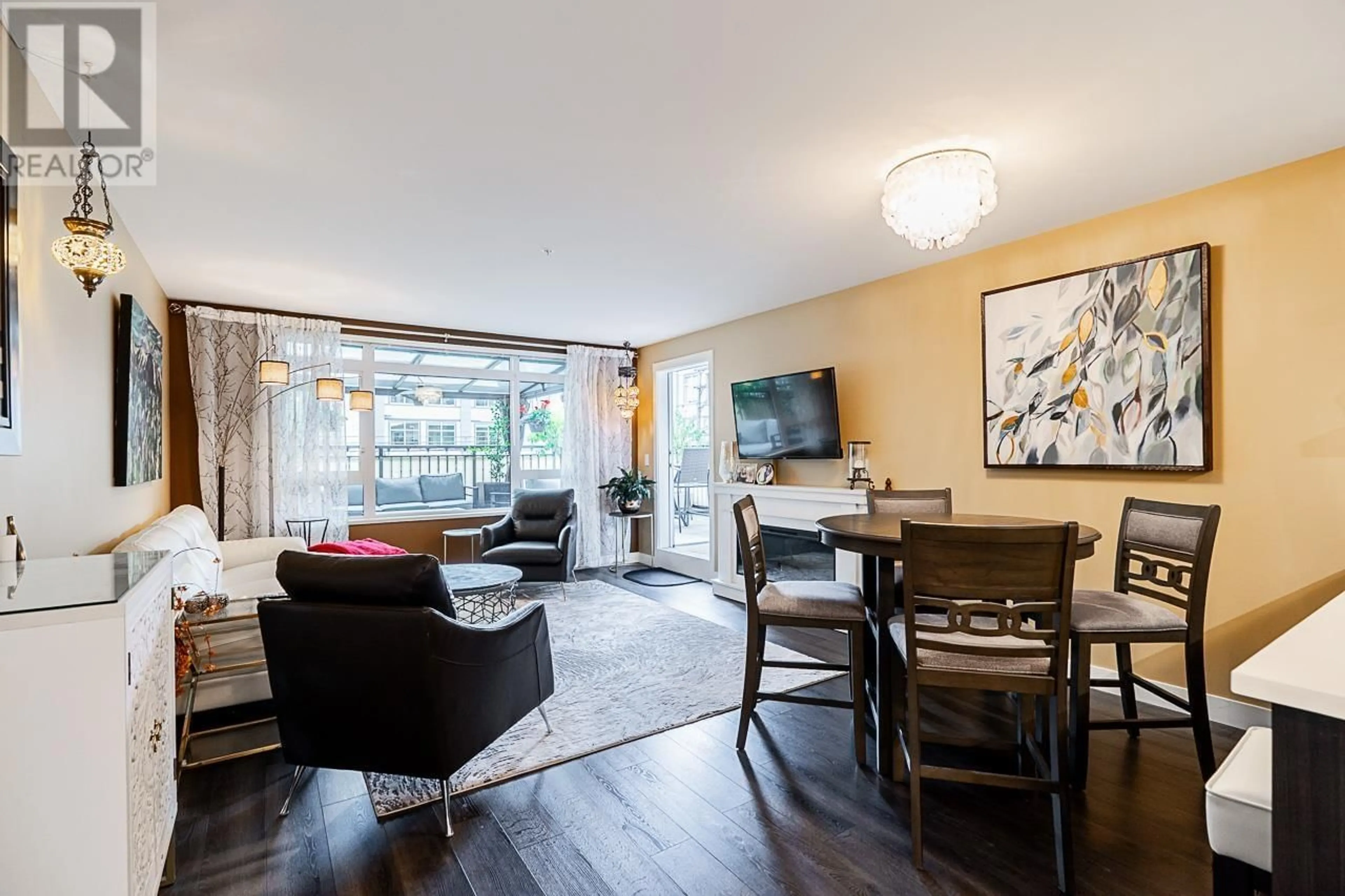 Living room with furniture, wood/laminate floor for 221 - 2525 CLARKE STREET, Port Moody British Columbia V3H0J3