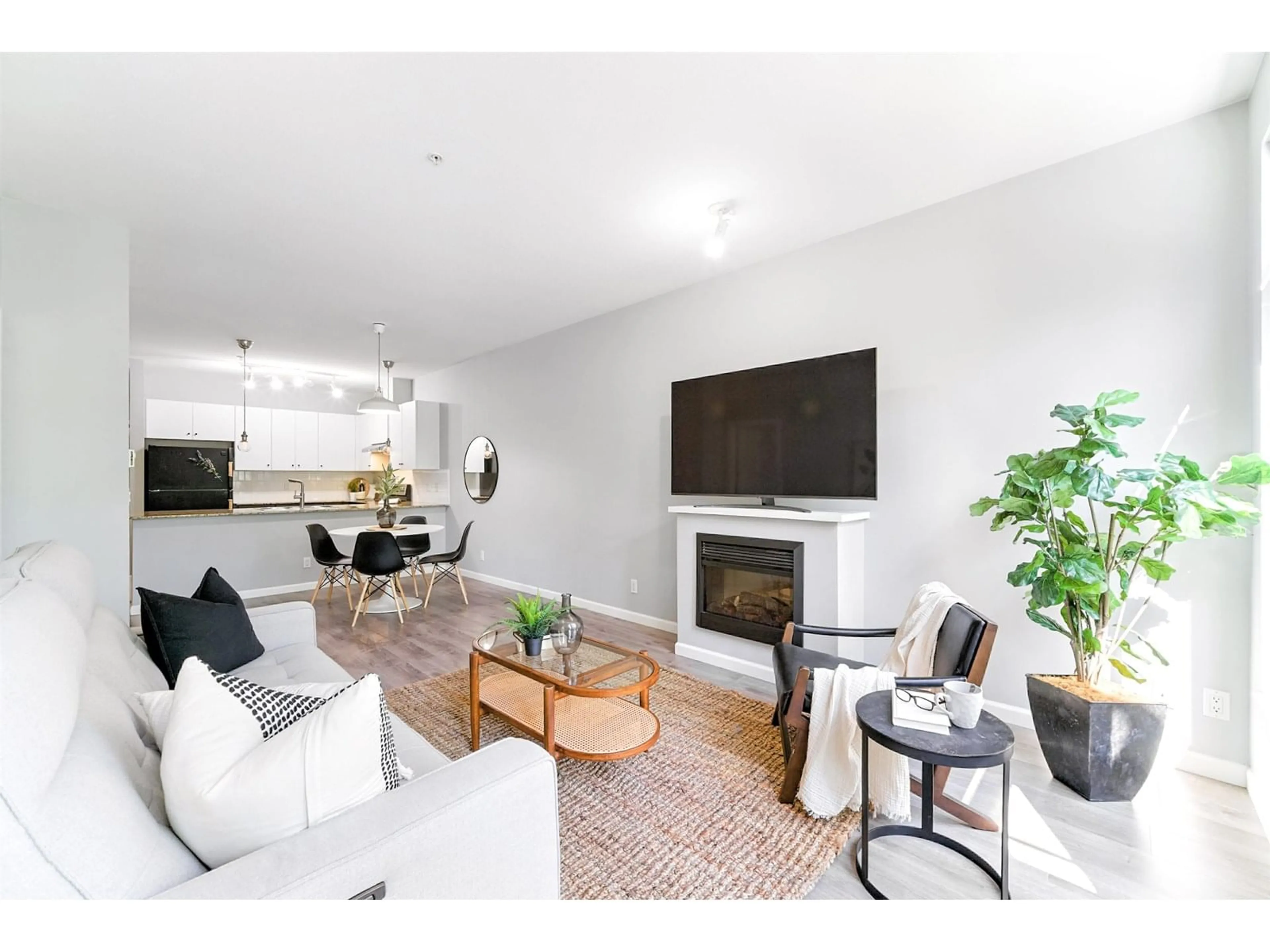 Living room with furniture, wood/laminate floor for 301 - 15385 101A, Surrey British Columbia V3R0B4