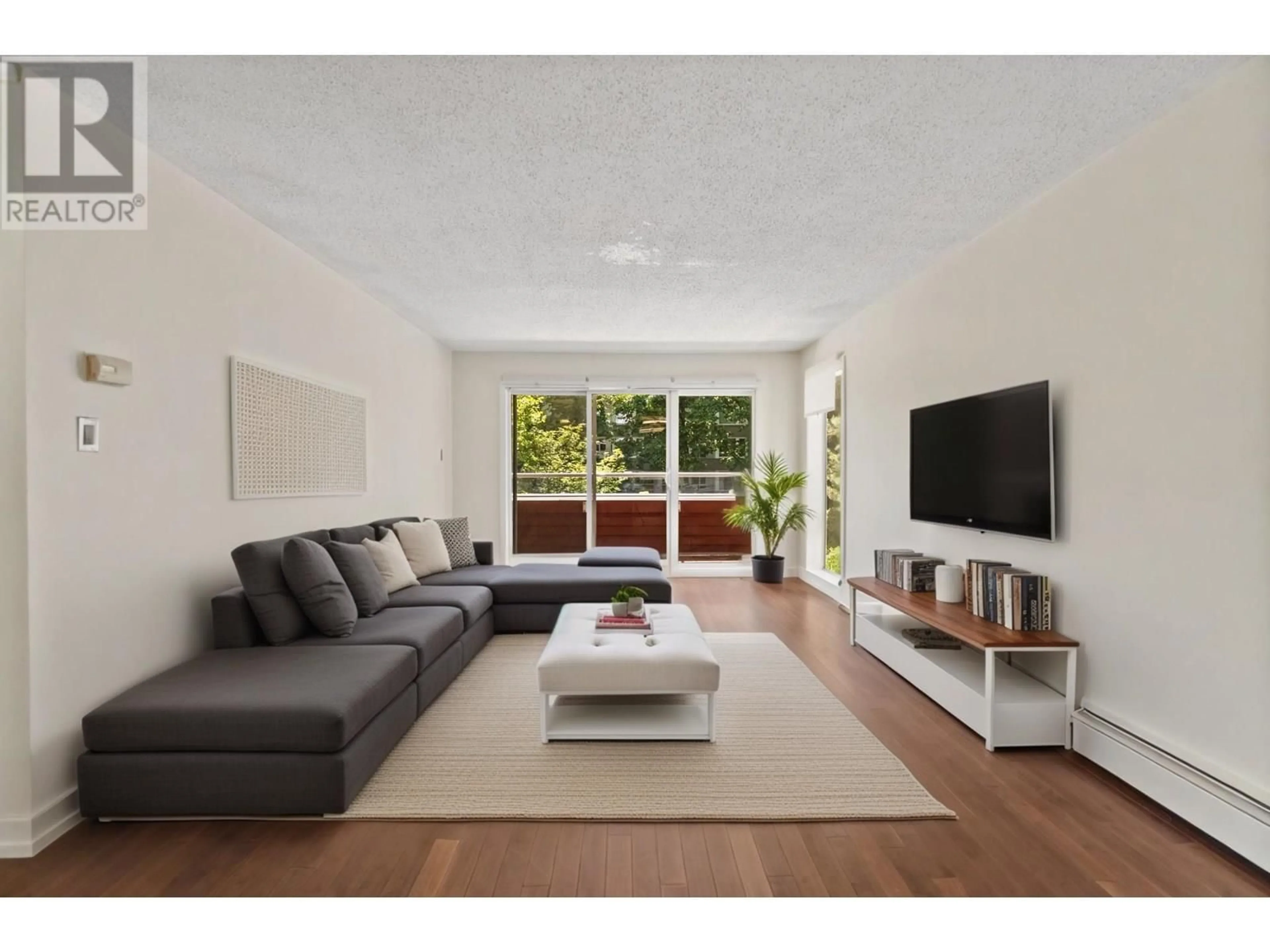 Living room with furniture, wood/laminate floor for 202 - 250 1ST STREET, North Vancouver British Columbia V7M1B4