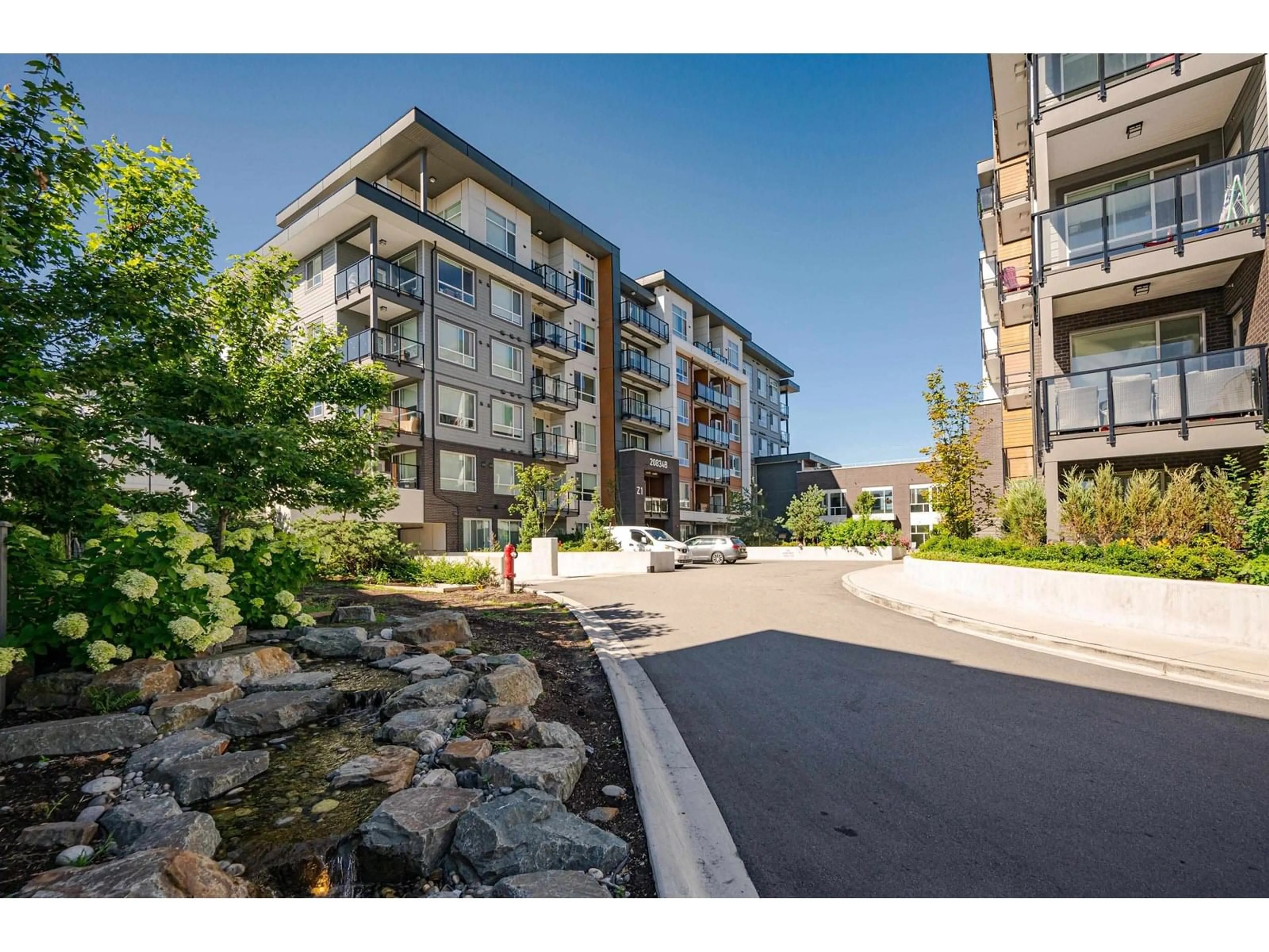 A pic from outside/outdoor area/front of a property/back of a property/a pic from drone, water/lake/river/ocean view for B307 - 20834 80, Langley British Columbia V2Y3M5