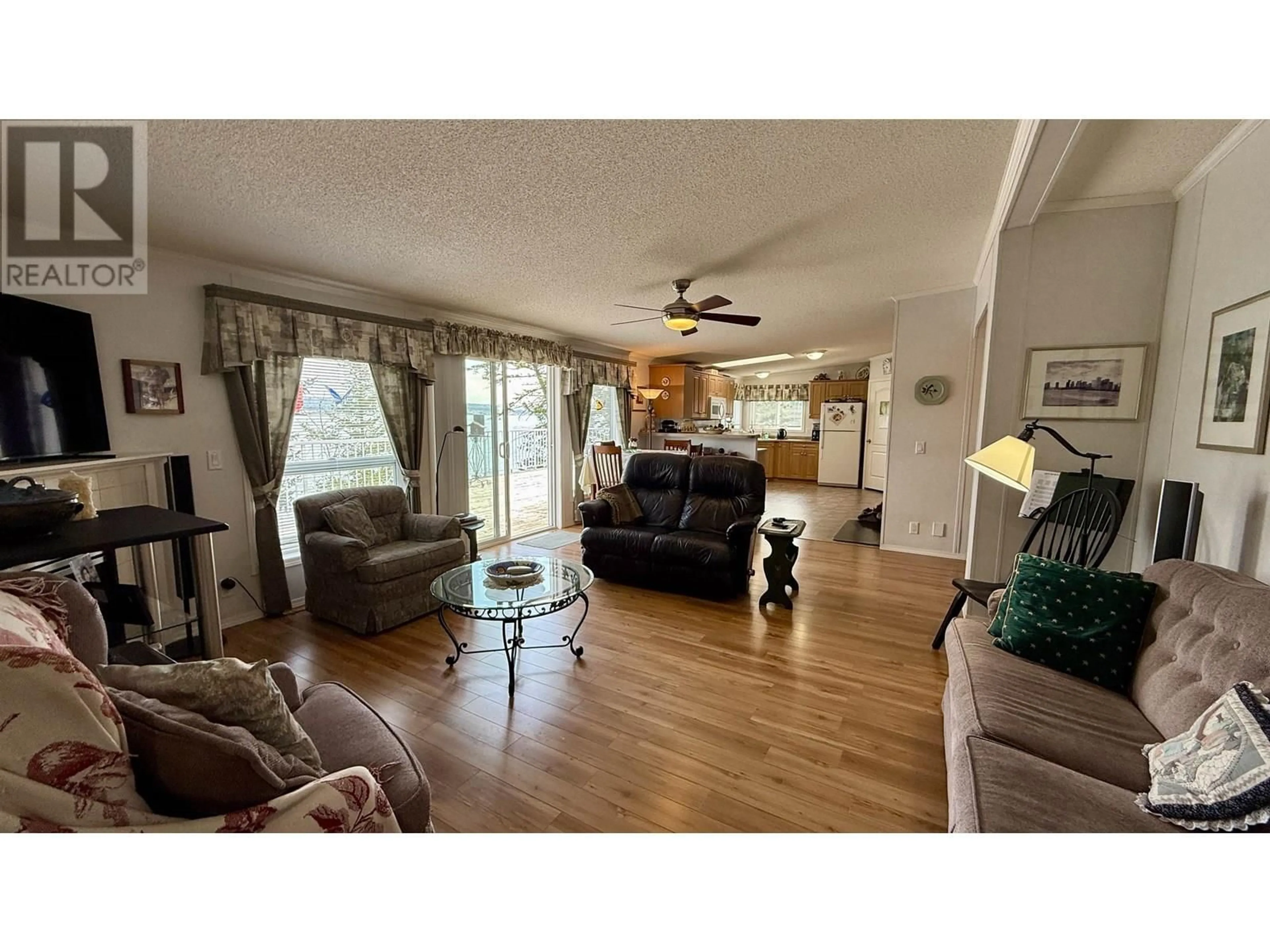 Living room with furniture, wood/laminate floor for 4574 CAVERLY ROAD, Lac La Hache British Columbia V0K1T0