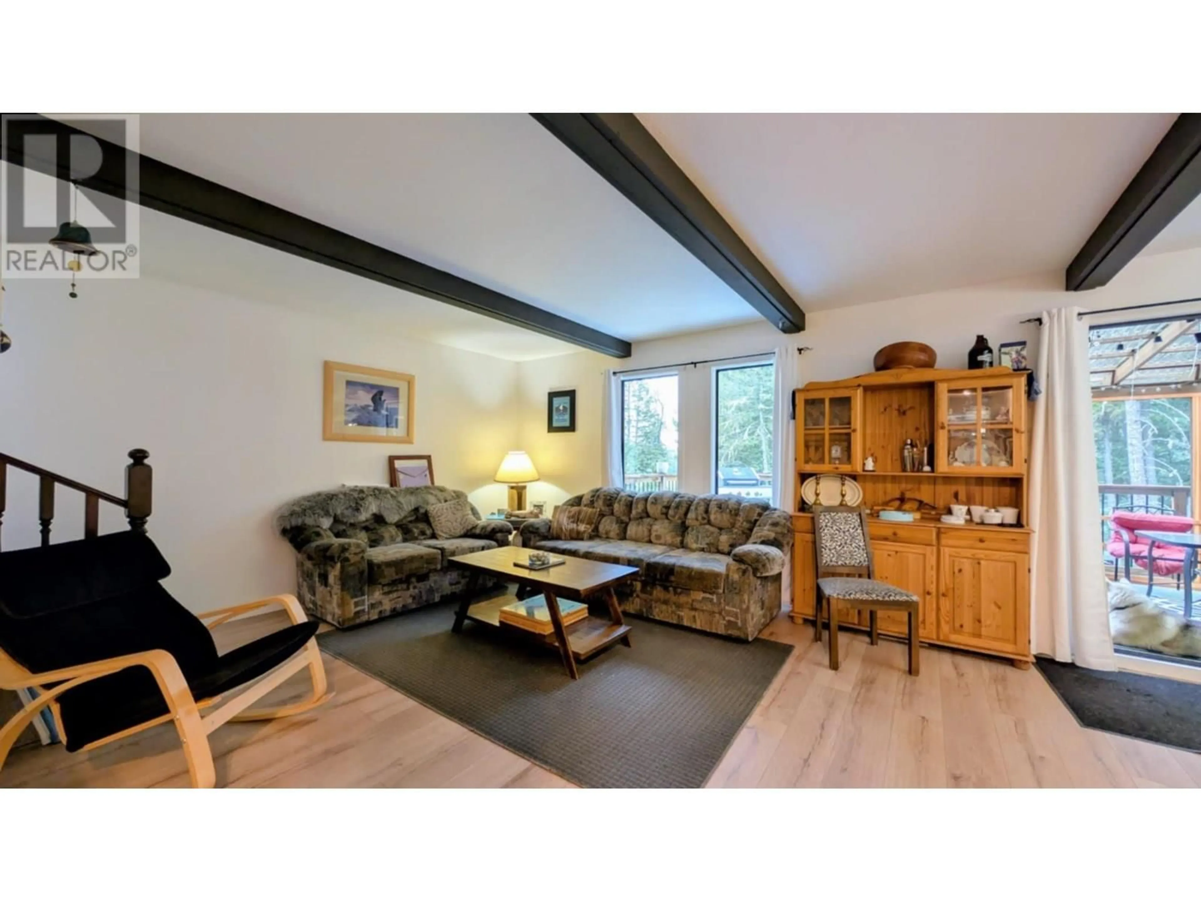 Living room with furniture, wood/laminate floor for 4927 GLOINNZUN CRESCENT, 108 Mile Ranch British Columbia V0K2Z0