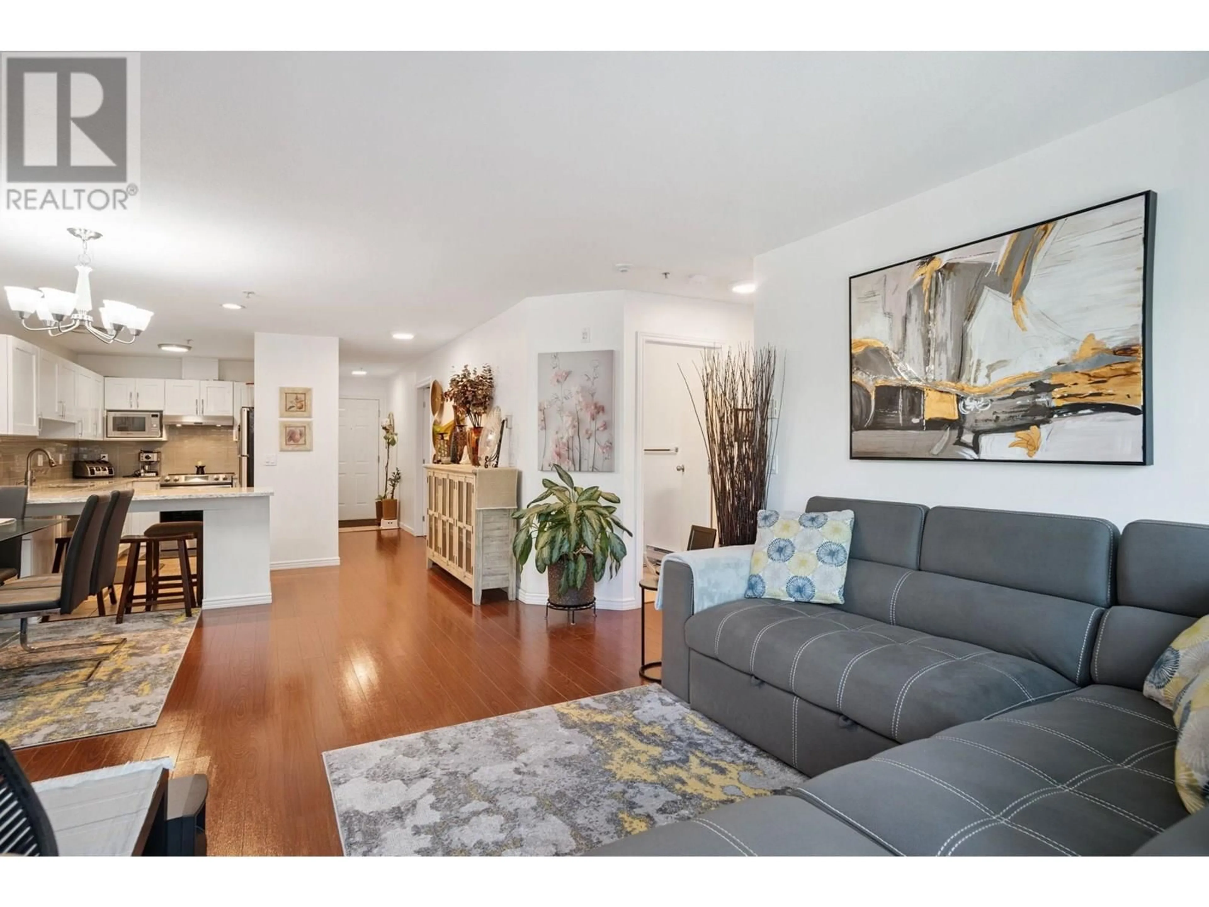 Living room with furniture, wood/laminate floor for 402 - 2983 CAMBRIDGE STREET, Port Coquitlam British Columbia V3B7N7