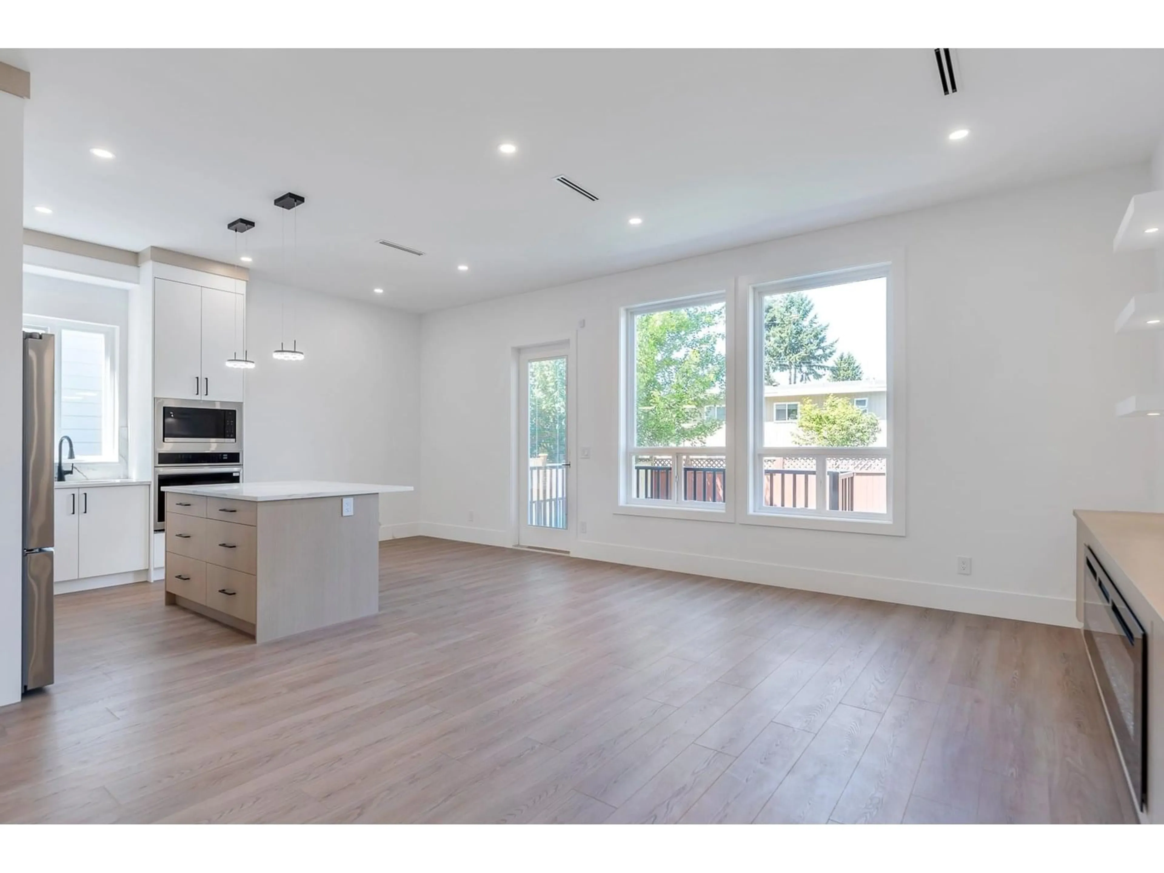 Open concept kitchen, wood/laminate floor for 11733 85A, Delta British Columbia V4C2V7