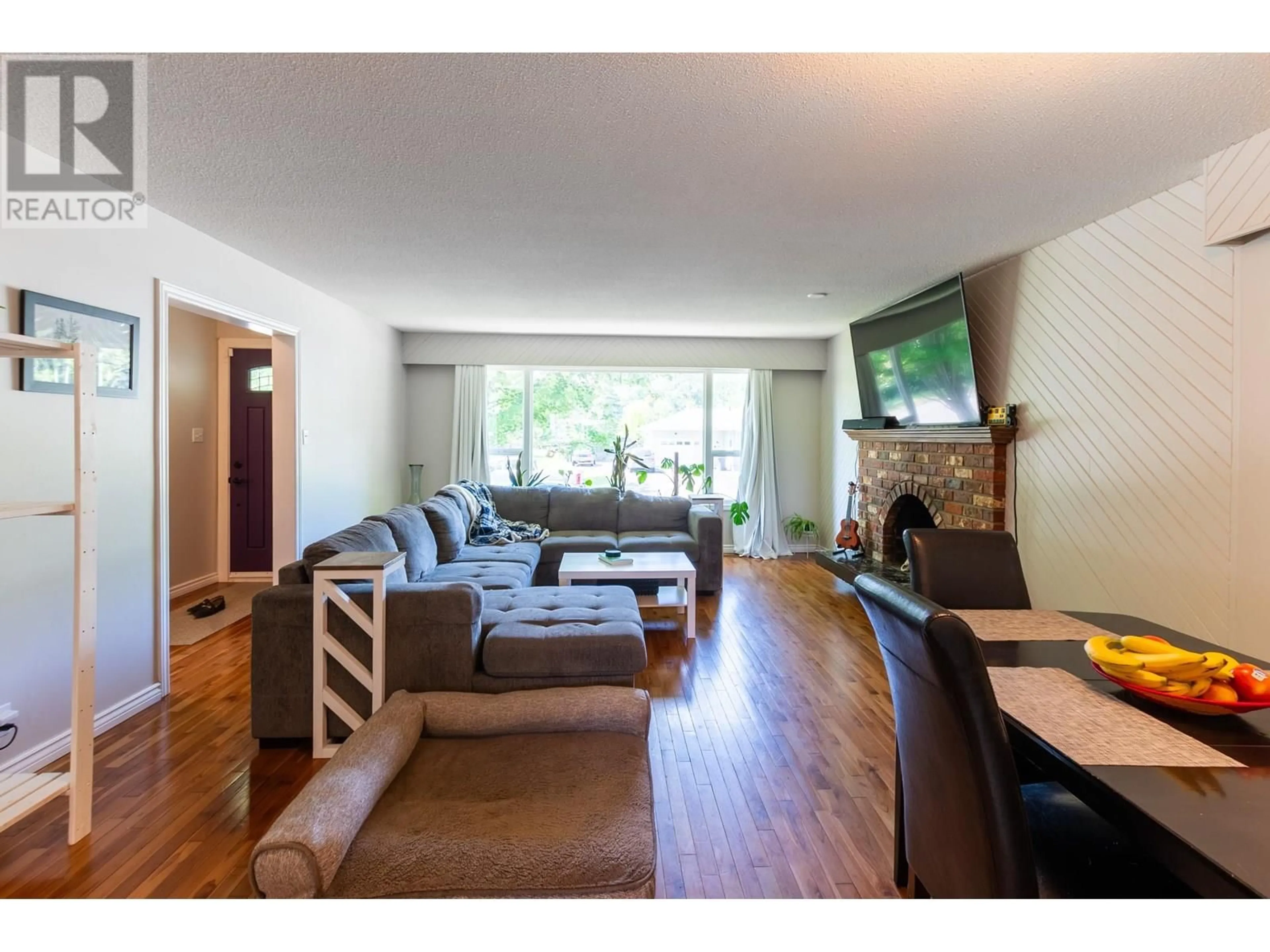 Living room with furniture, wood/laminate floor for 1678 KENWOOD STREET, Prince George British Columbia V2L1S2