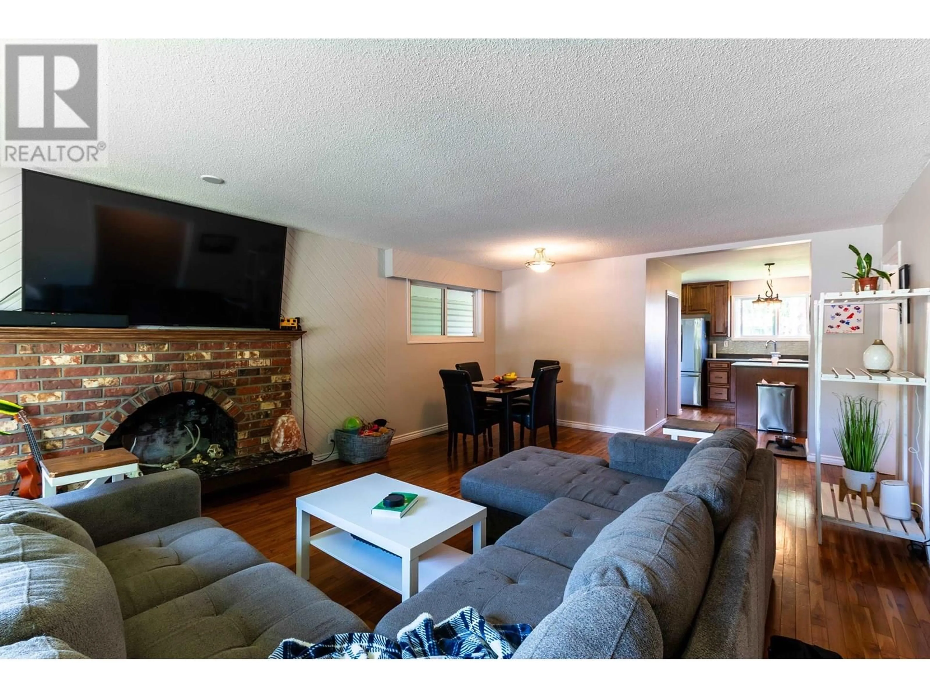 Living room with furniture, wood/laminate floor for 1678 KENWOOD STREET, Prince George British Columbia V2L1S2