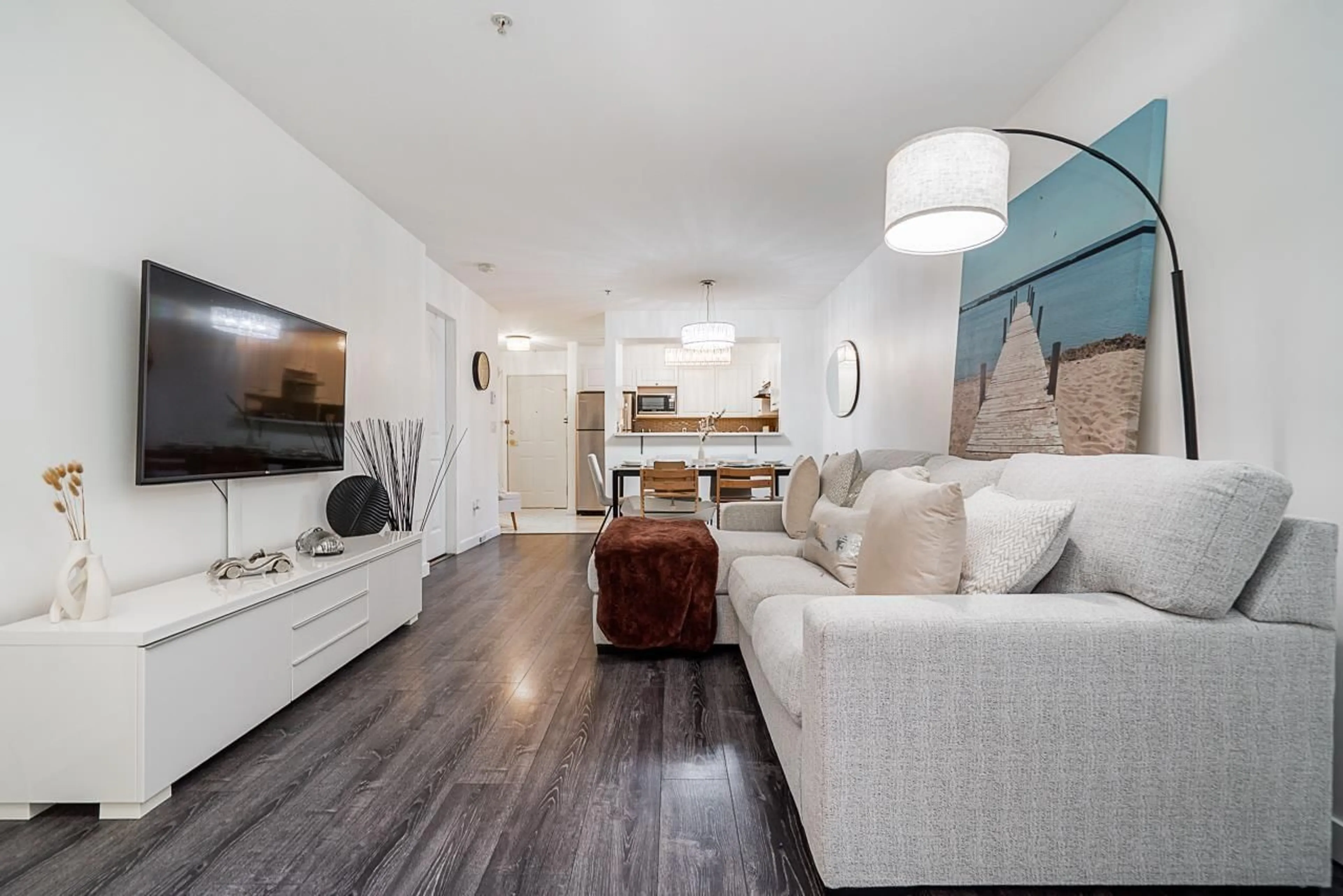 Living room with furniture, wood/laminate floor for 110 - 8110 120A, Surrey British Columbia V3W3P3