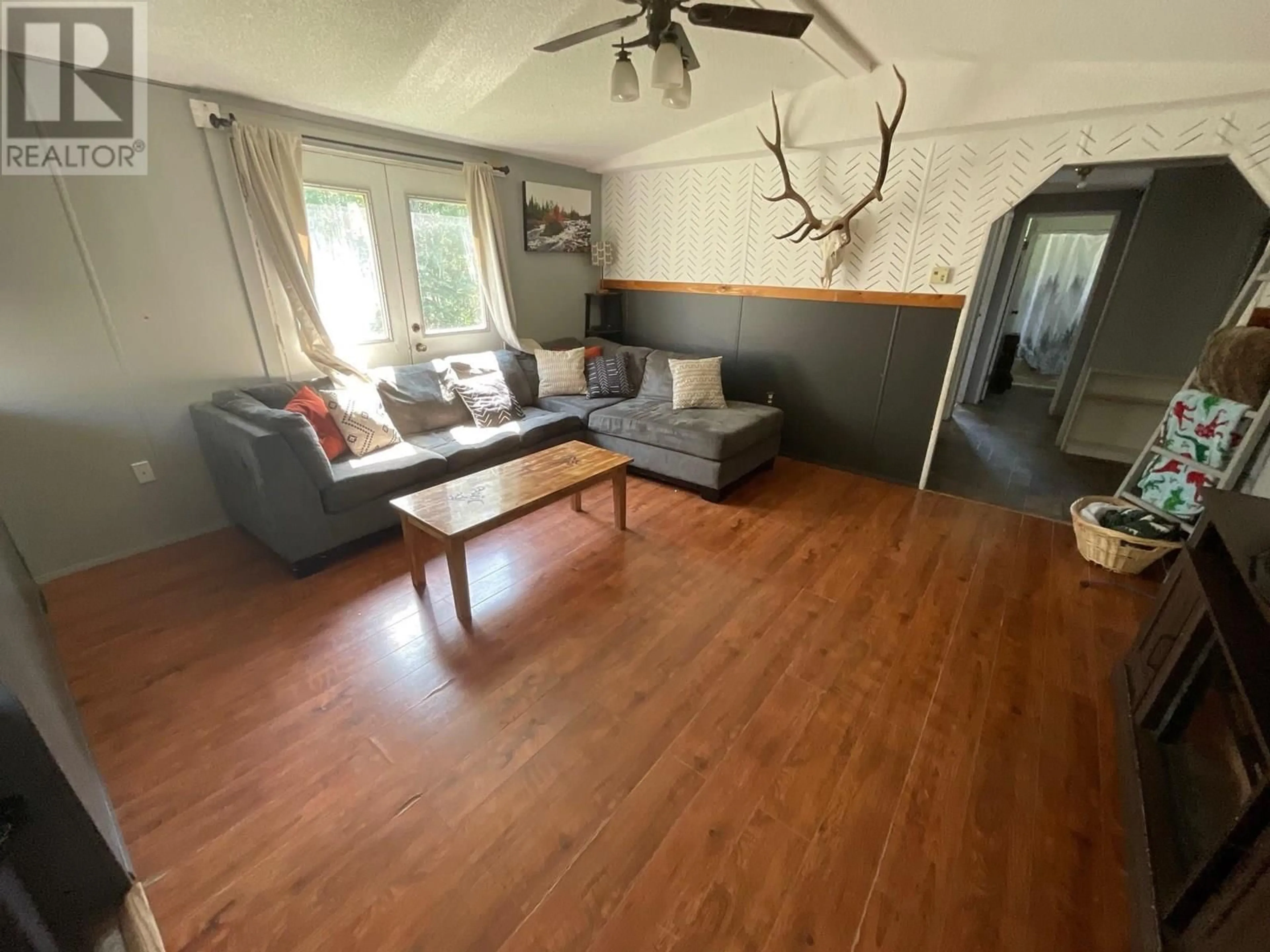 Living room with furniture, wood/laminate floor for 14202 250 ROAD, Charlie Lake British Columbia V0C1H0