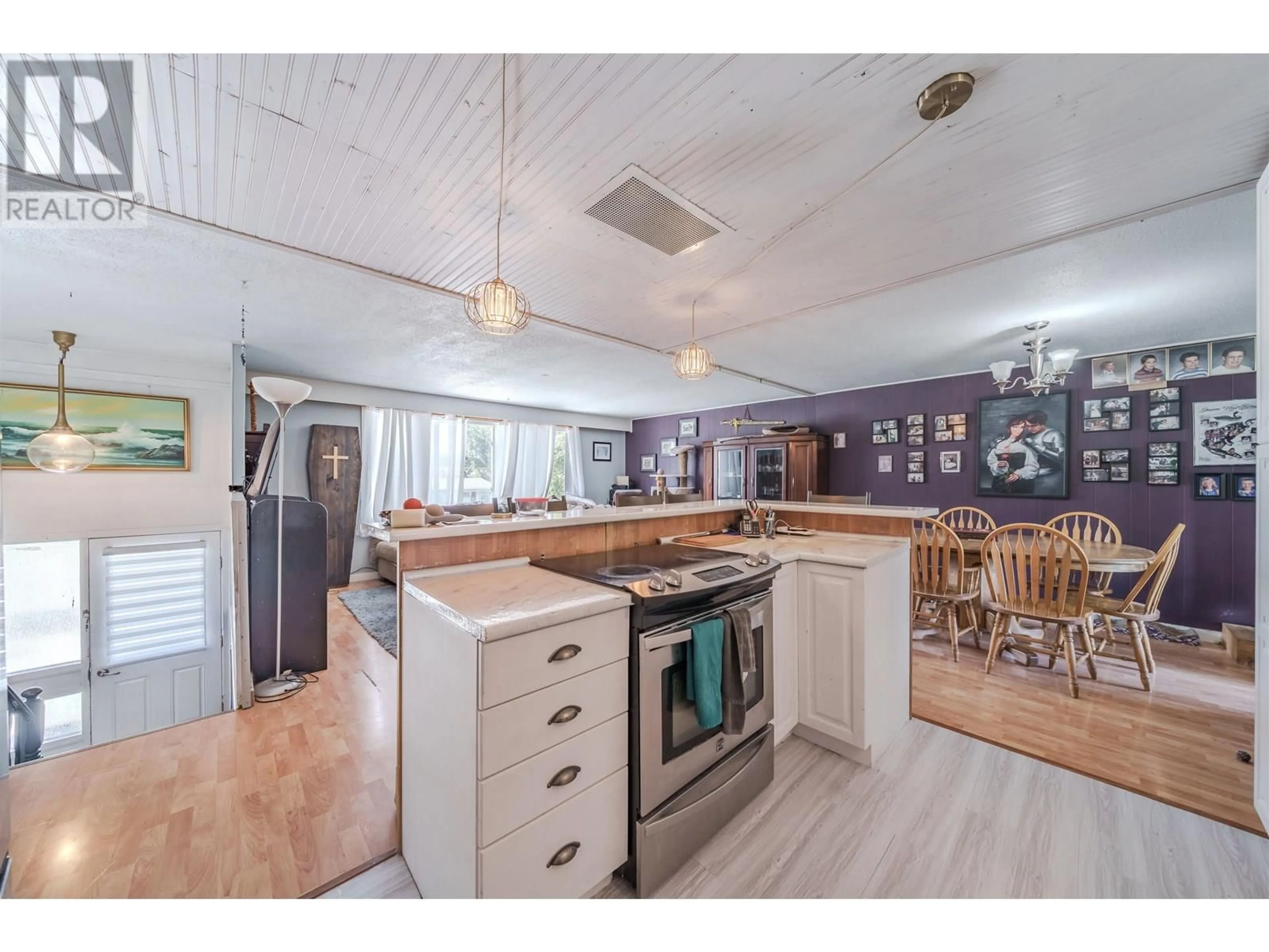 Open concept kitchen, wood/laminate floor for 287 ELM AVENUE, 100 Mile House British Columbia V0K2E0
