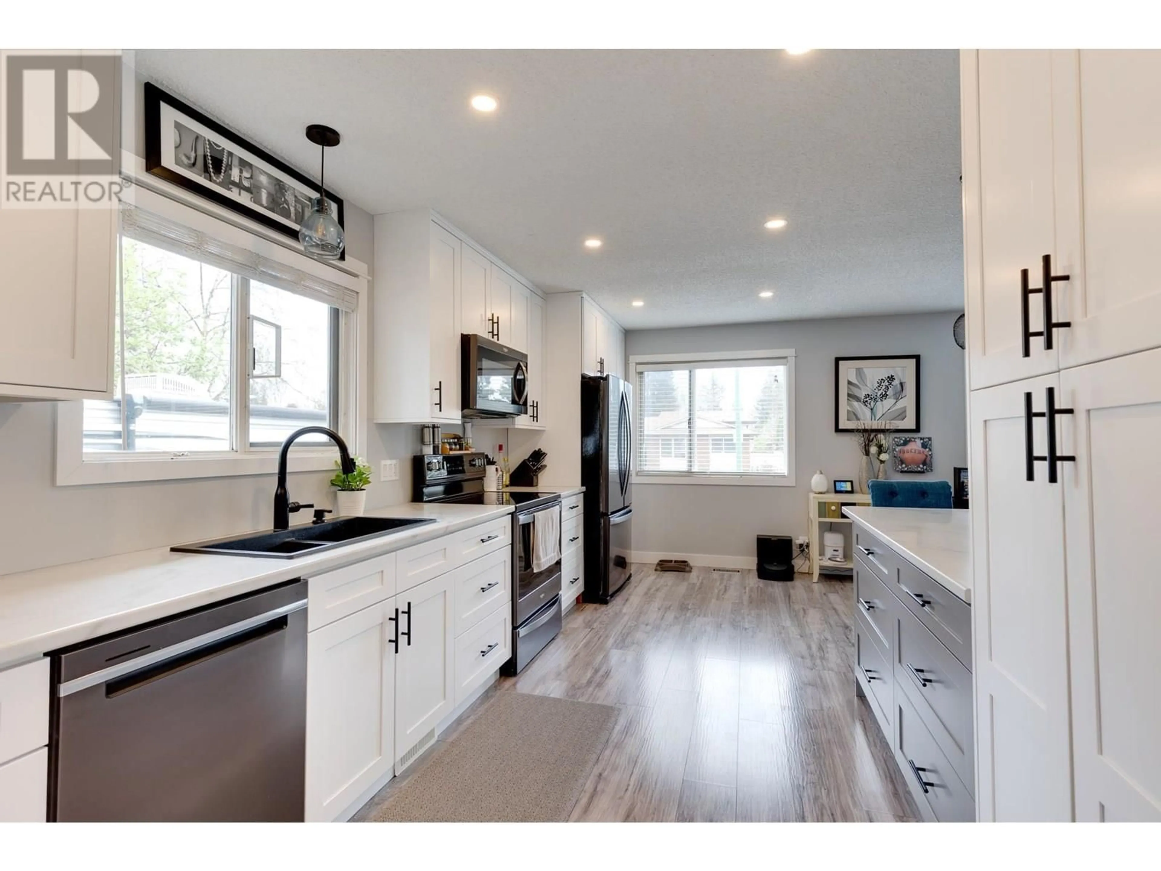 Open concept kitchen, wood/laminate floor for 7741 LANCASTER CRESCENT, Prince George British Columbia V2N3R2