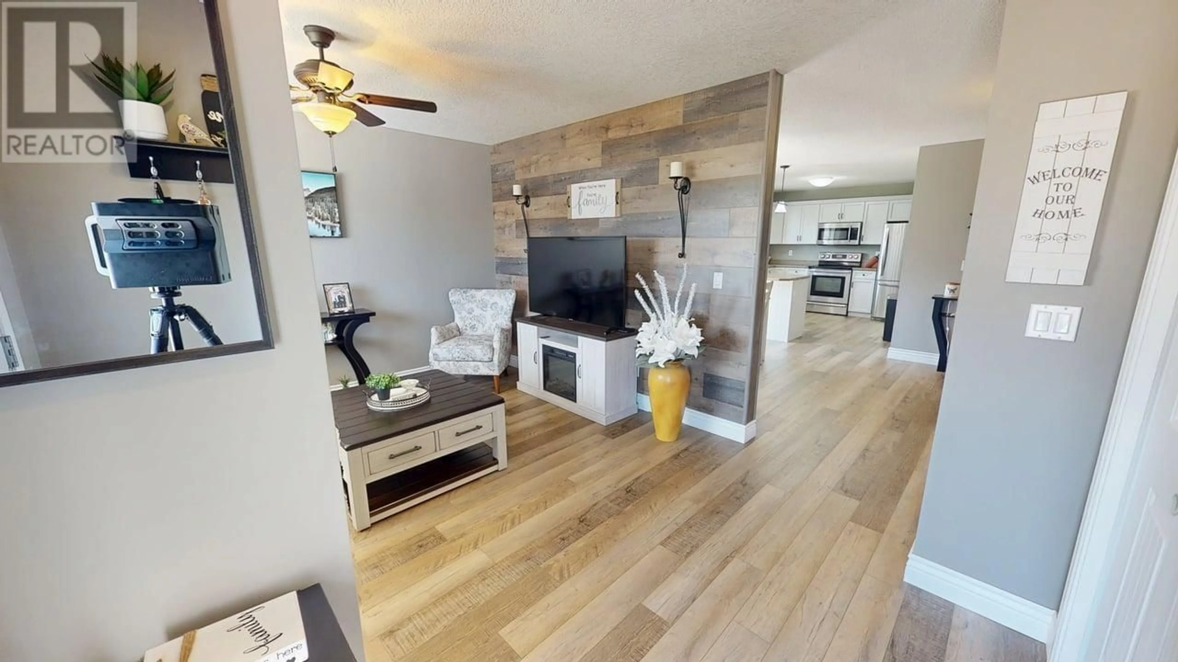 Living room with furniture, wood/laminate floor for 11704 97 STREET, Fort St. John British Columbia V1J0E9