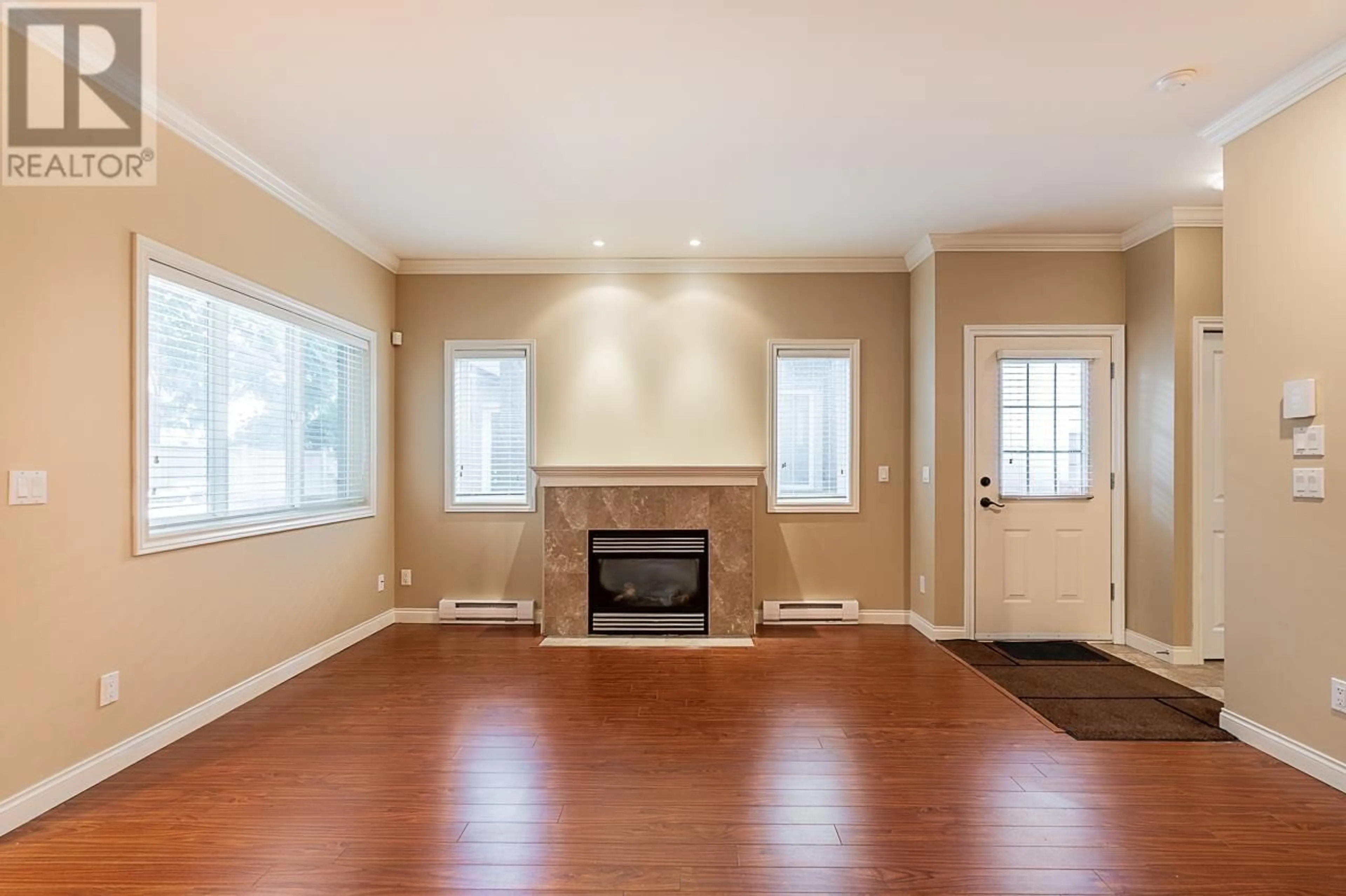 Living room with furniture, wood/laminate floor for 11 - 8311 NO. 2 ROAD, Richmond British Columbia V7C3M2