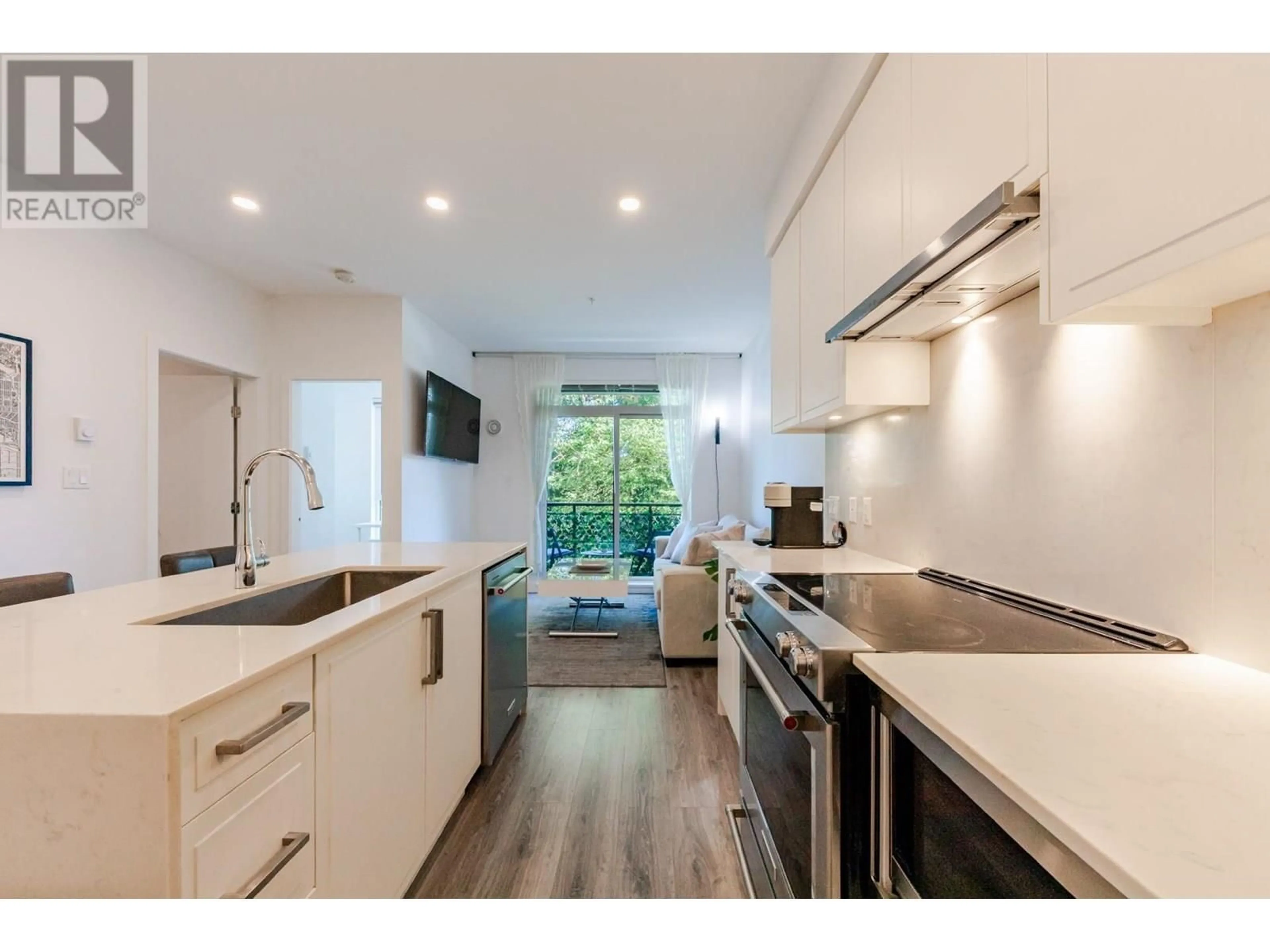 Open concept kitchen, wood/laminate floor for 401 - 700 CLARKE ROAD, Coquitlam British Columbia V3J0K5