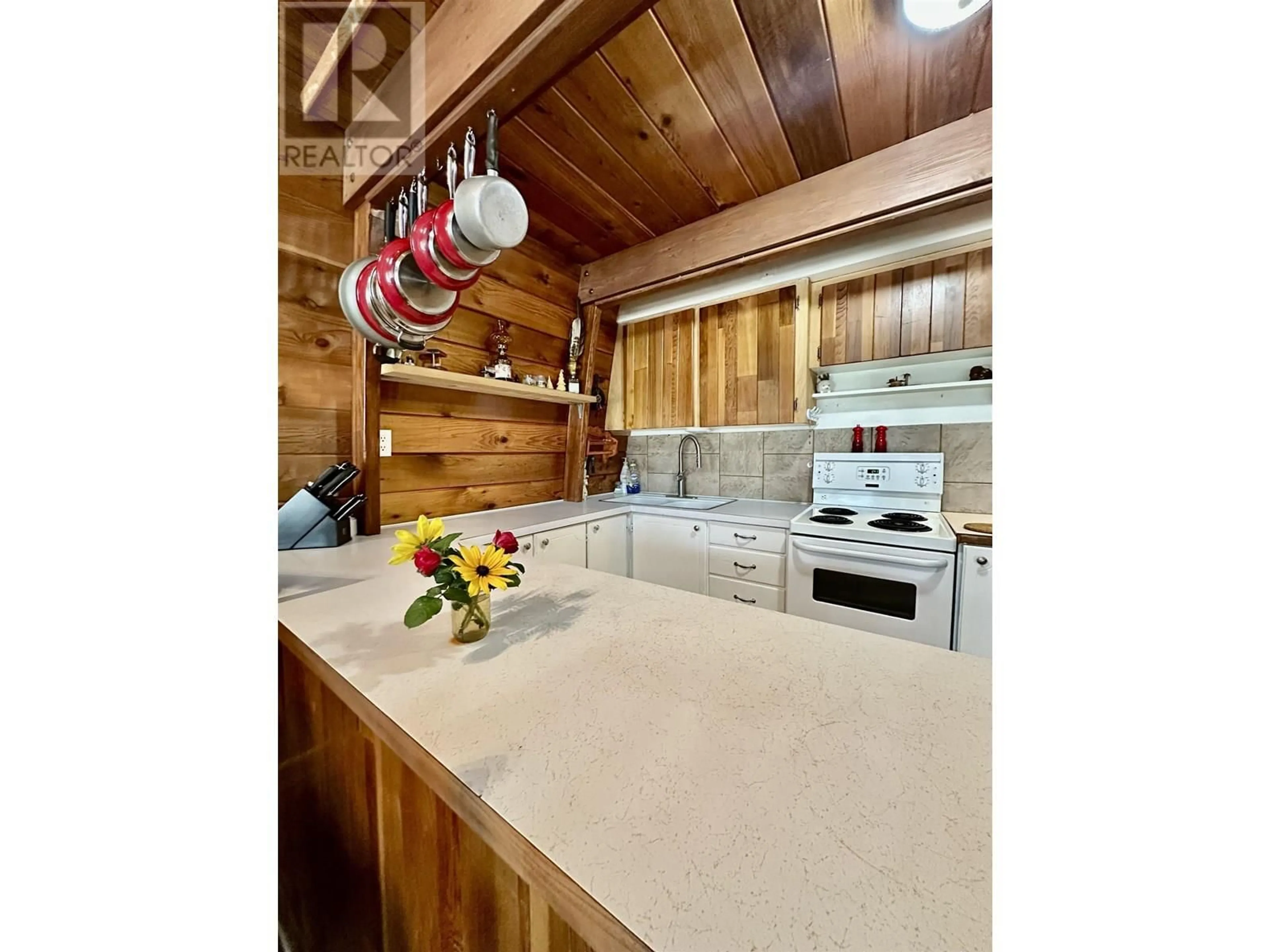 Open concept kitchen, wood/laminate floor for 4772 KITWANGA DRIVE, 108 Mile Ranch British Columbia V0K2Z0