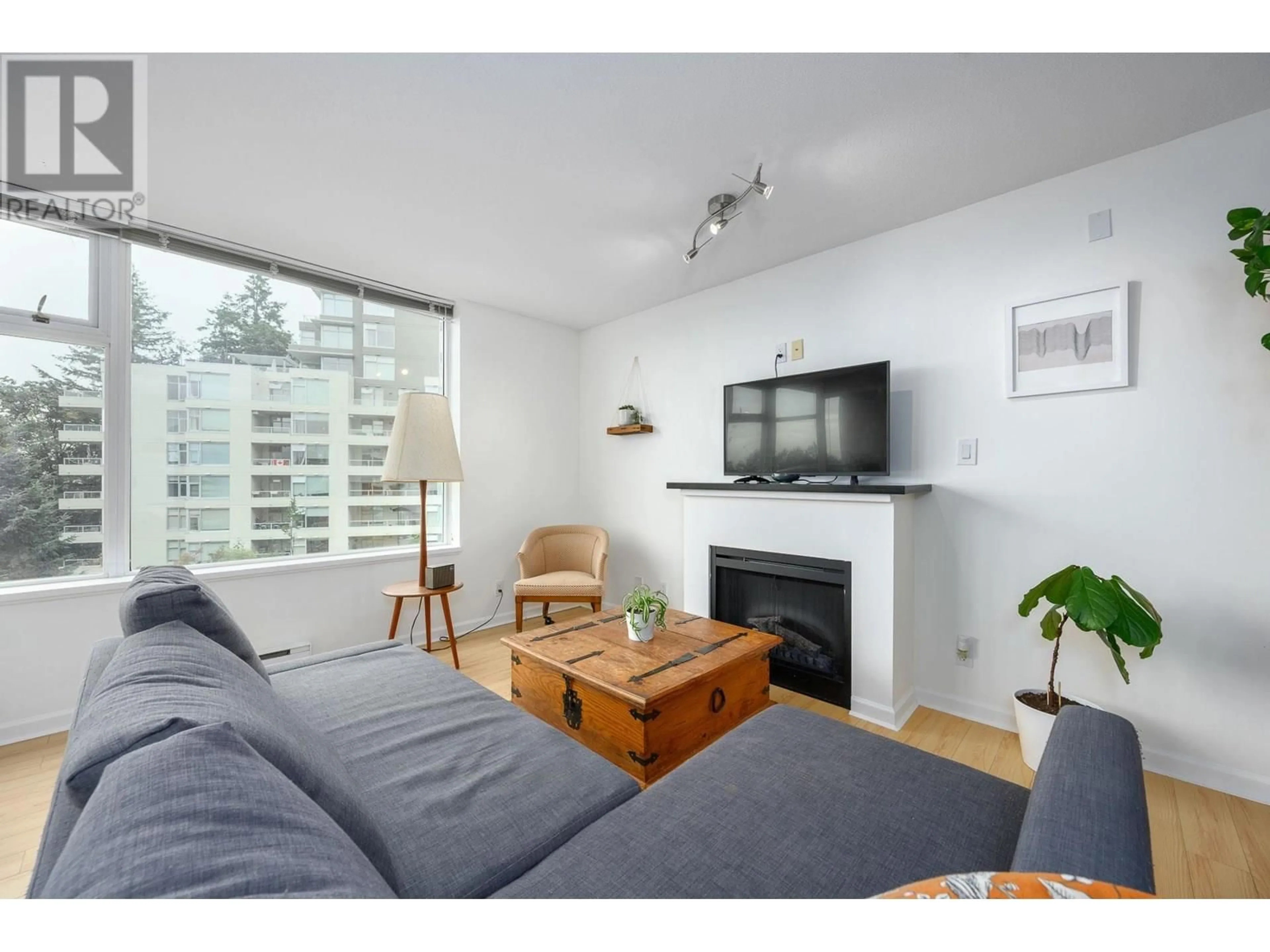 Living room with furniture, wood/laminate floor for 207 - 9288 UNIVERSITY CRESCENT, Burnaby British Columbia V5A4X7