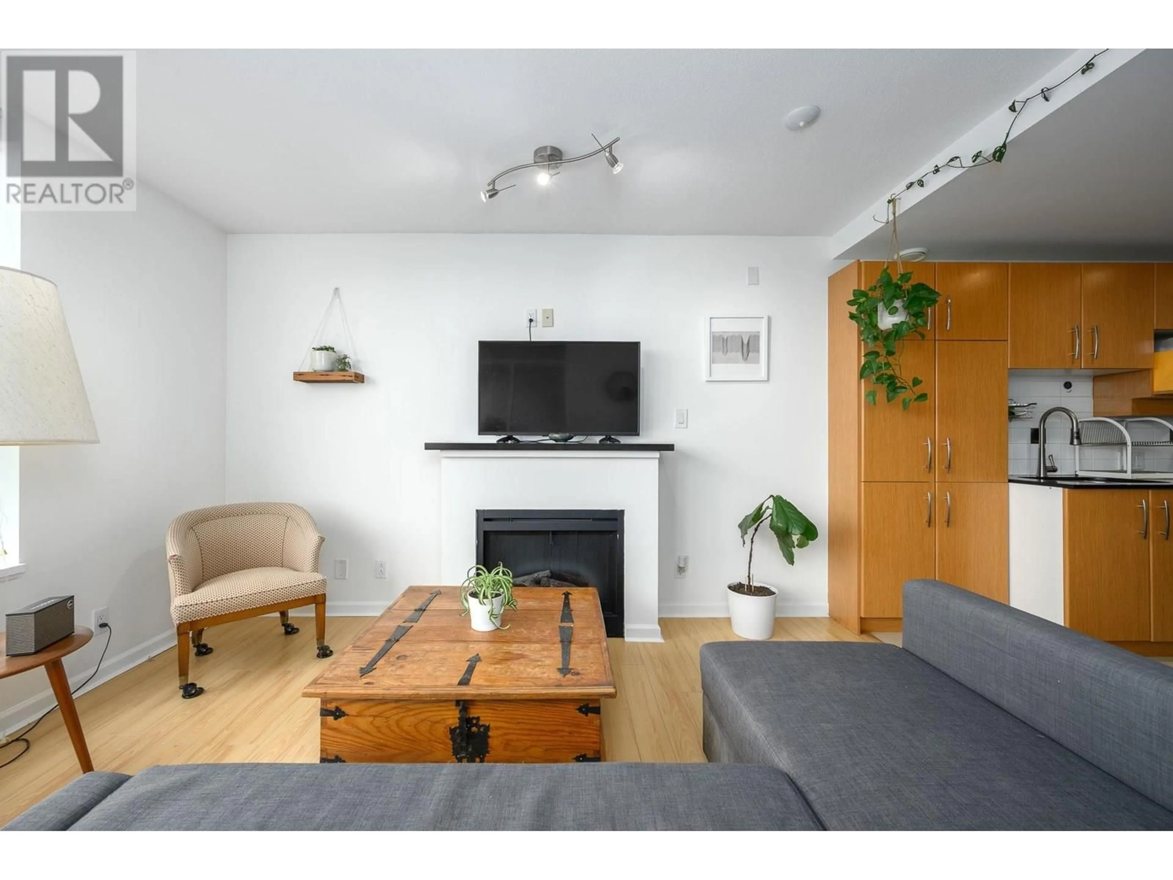 Living room with furniture, wood/laminate floor for 207 - 9288 UNIVERSITY CRESCENT, Burnaby British Columbia V5A4X7