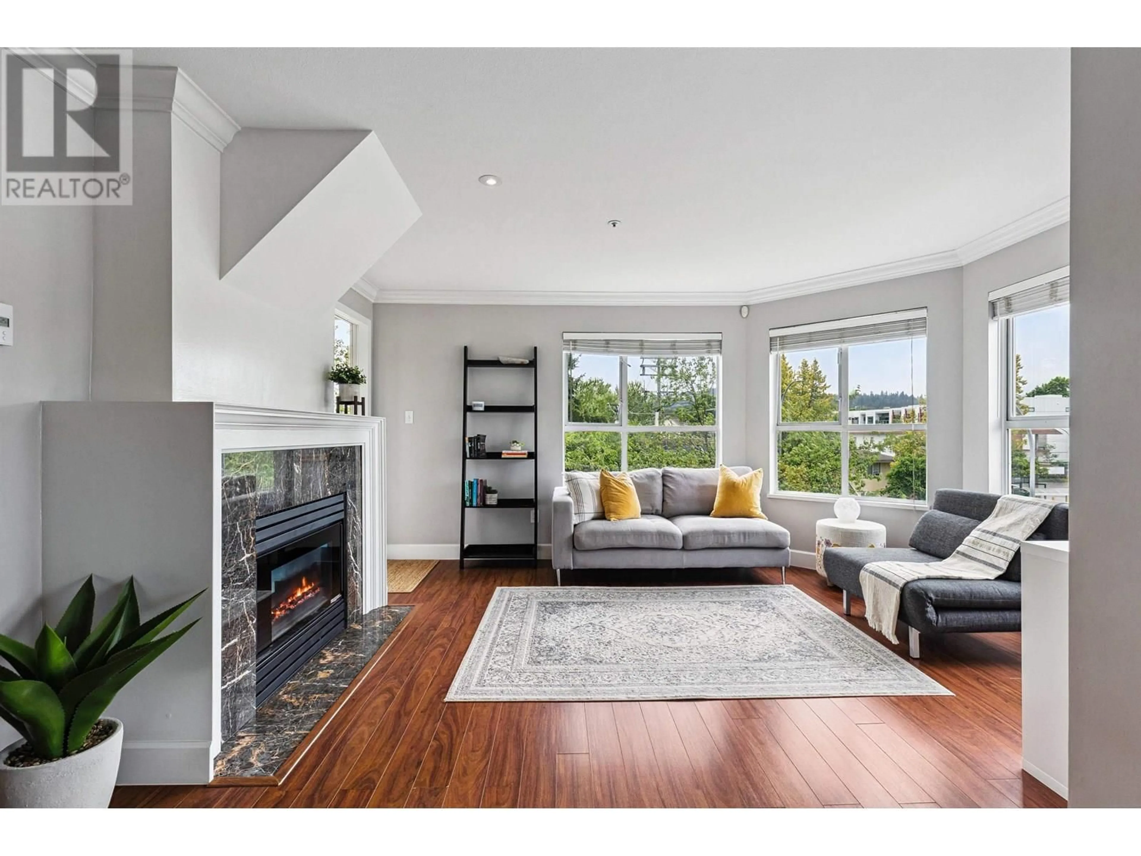 Living room with furniture, wood/laminate floor for 203 - 2285 PITT RIVER ROAD, Port Coquitlam British Columbia V3C1R7