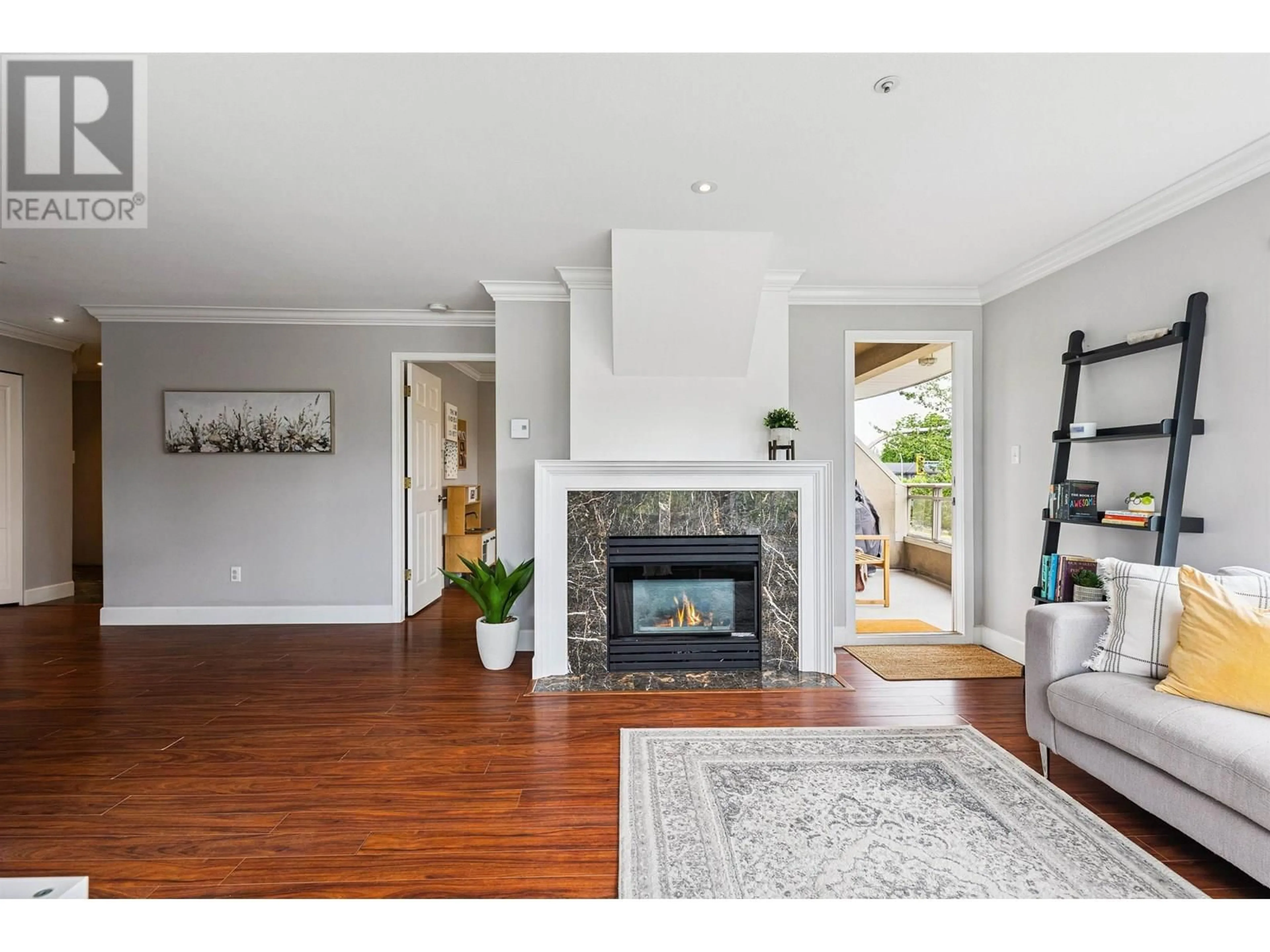 Living room with furniture, wood/laminate floor for 203 - 2285 PITT RIVER ROAD, Port Coquitlam British Columbia V3C1R7