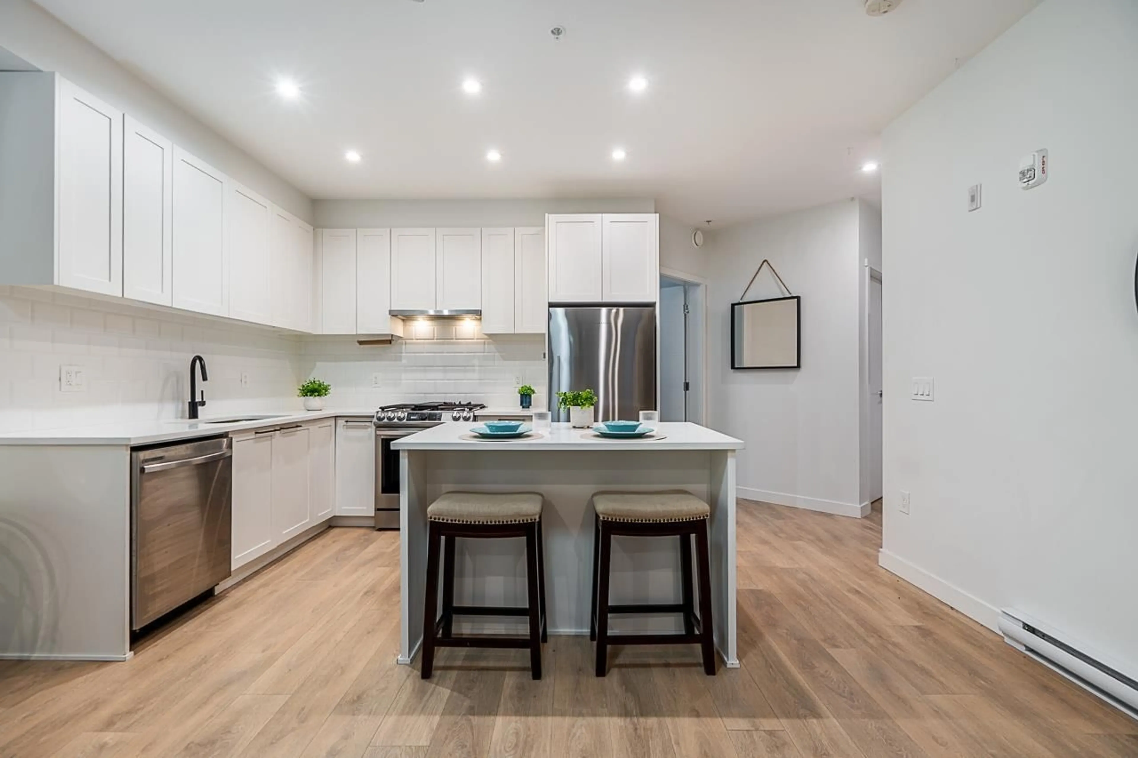 Open concept kitchen, wood/laminate floor for 319 - 5415 BRYDON, Langley British Columbia V3A0N4