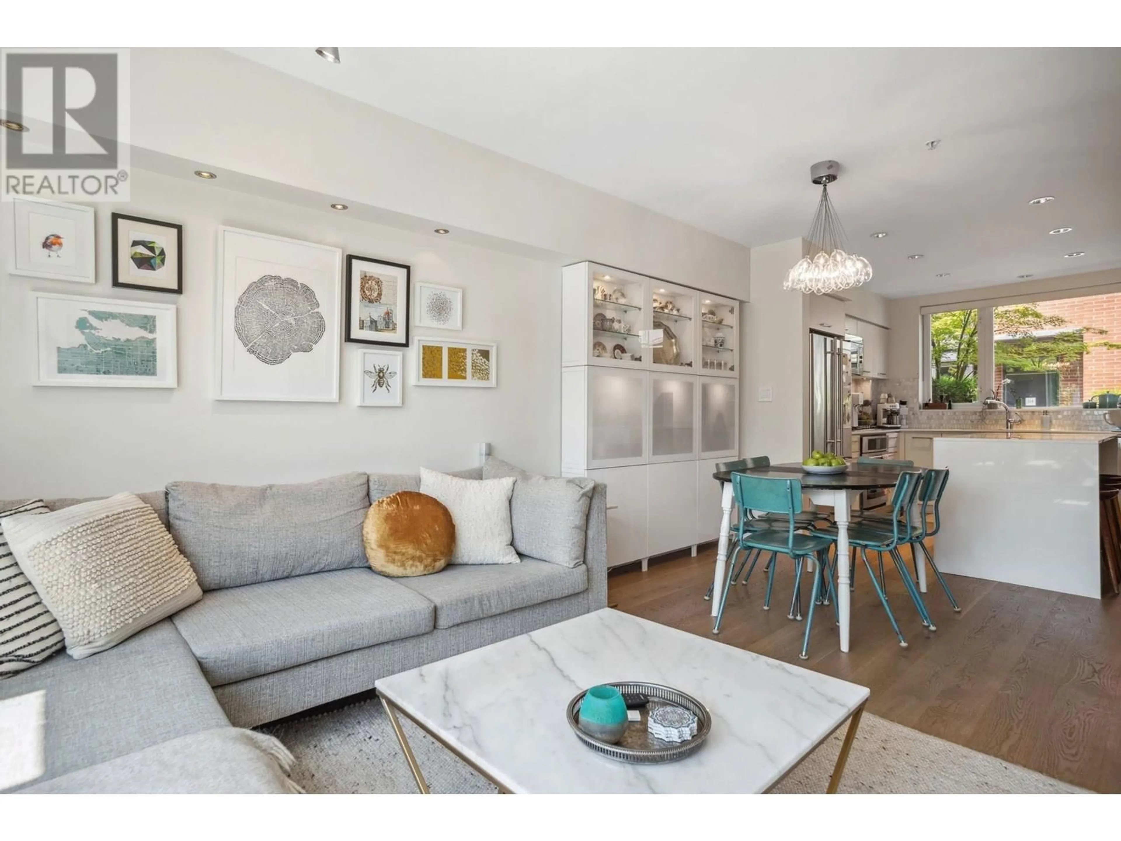 Living room with furniture, wood/laminate floor for 207 - 1961 COLLINGWOOD STREET, Vancouver British Columbia V6R3K6