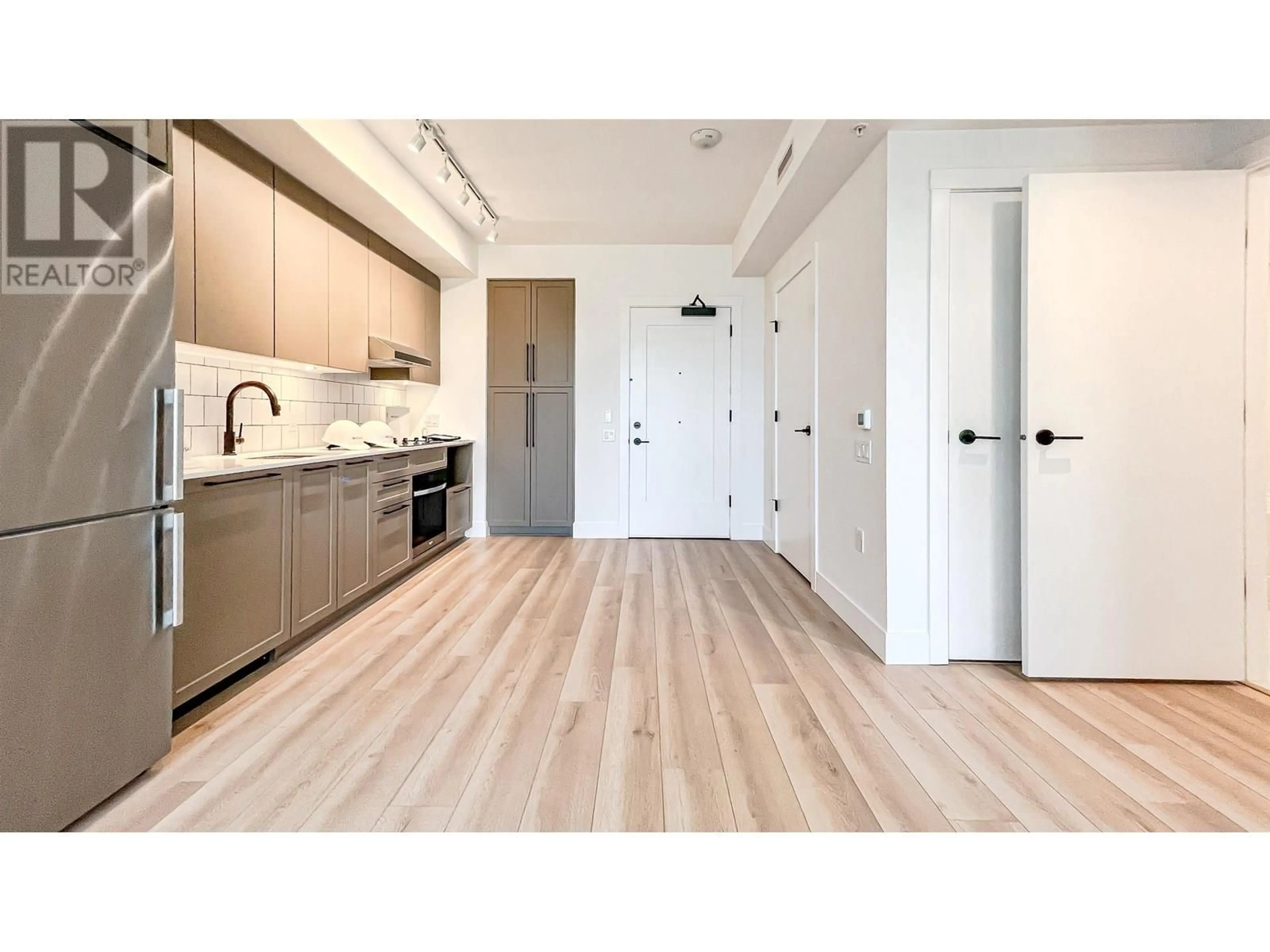 Open concept kitchen, wood/laminate floor for 705 - 8750 UNIVERSITY CRESCENT, Burnaby British Columbia V5A0G9
