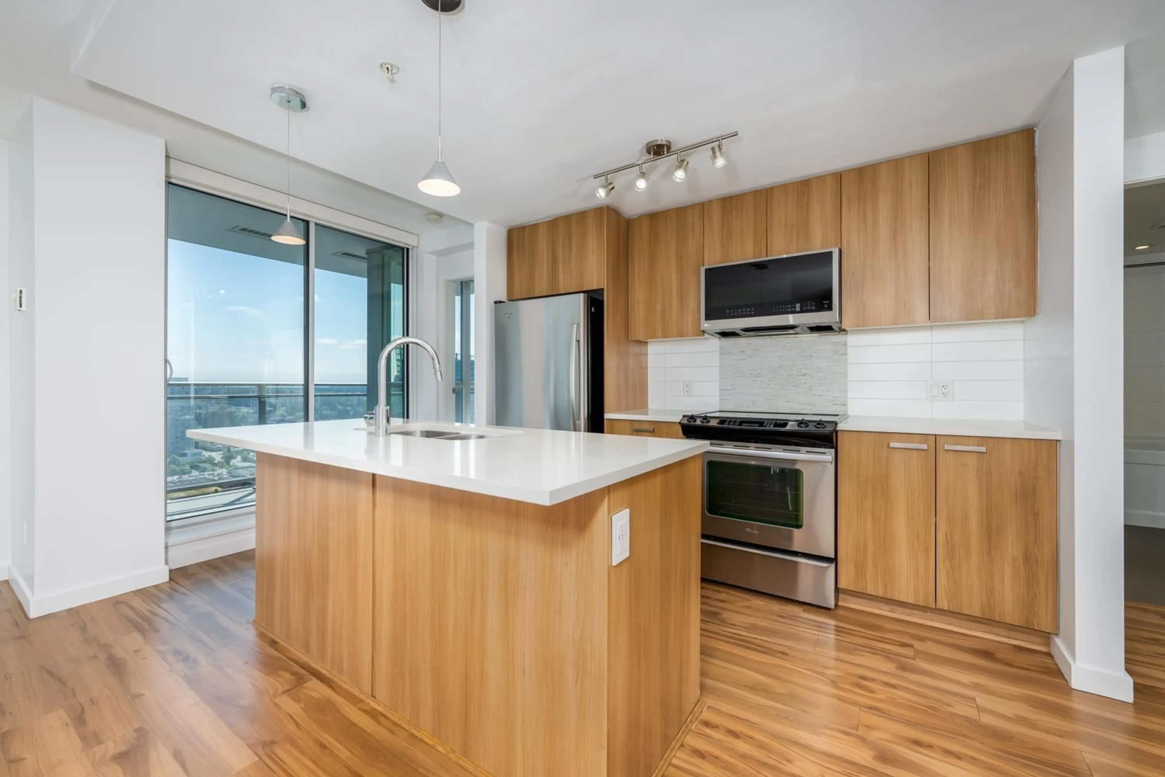 Open concept kitchen, wood/laminate floor for 3305 - 13325 102A, Surrey British Columbia V3T0J5