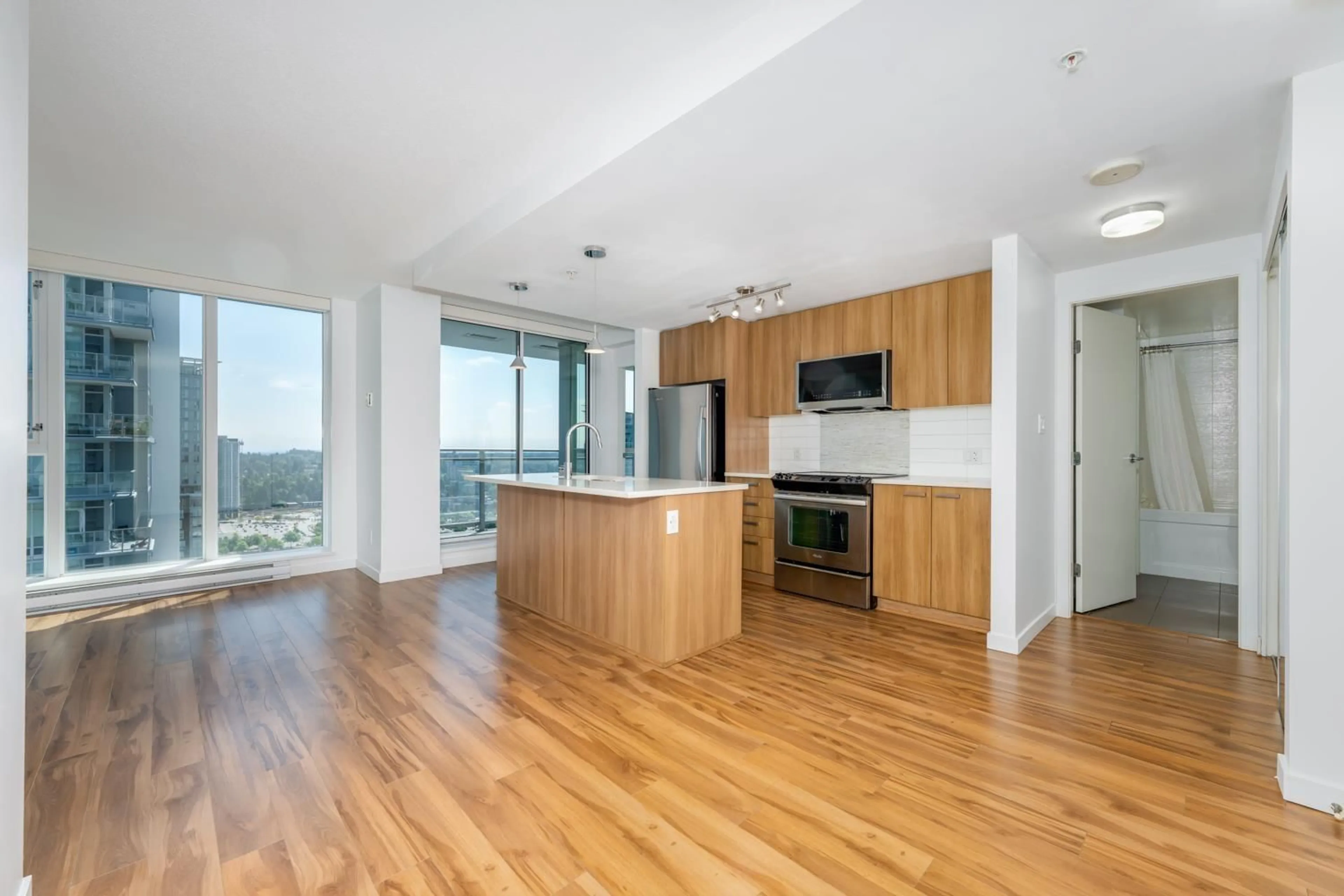 Open concept kitchen, wood/laminate floor for 3305 - 13325 102A, Surrey British Columbia V3T0J5