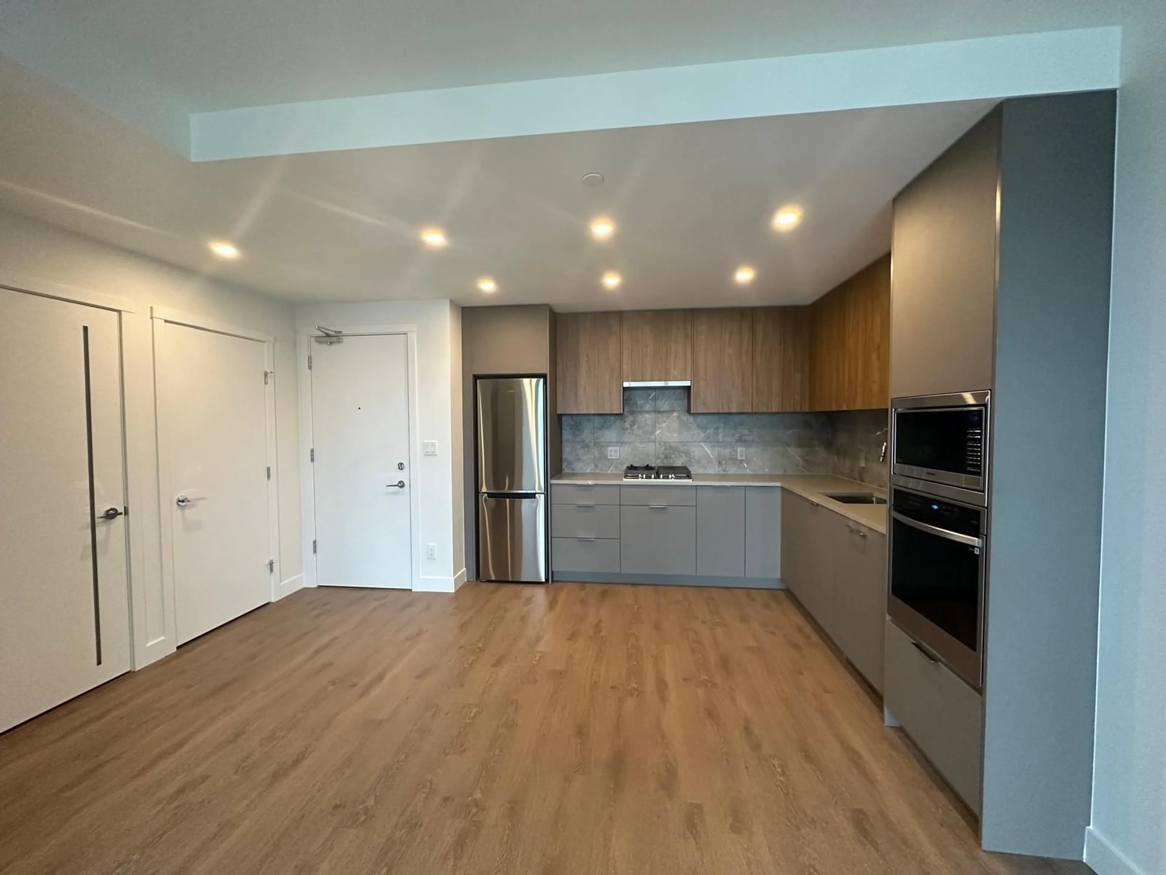 Open concept kitchen, wood/laminate floor for 2401 - 13359 OLD YALE, Surrey British Columbia V3T0S4