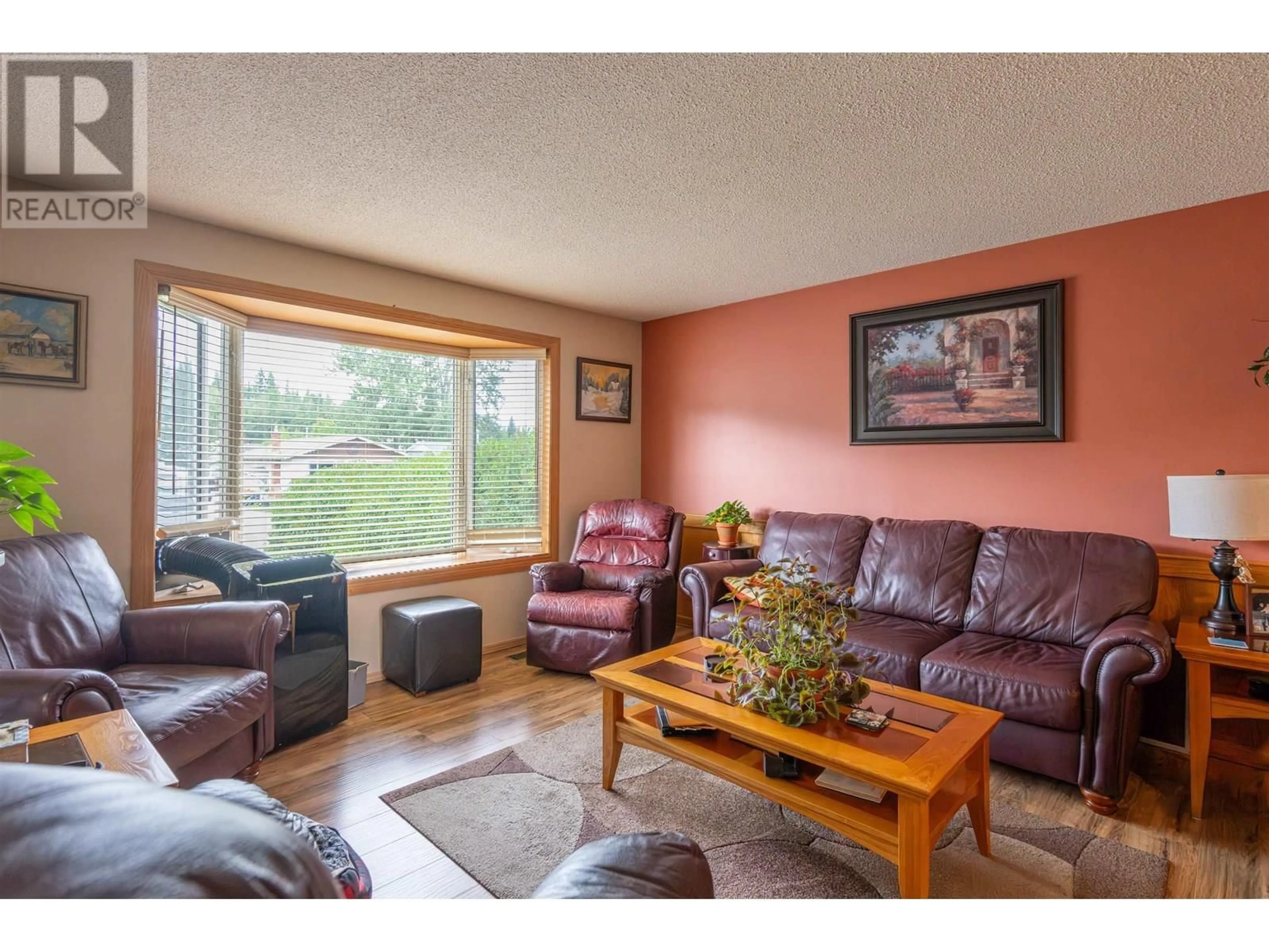 Living room with furniture, wood/laminate floor for 7182 GUELPH PLACE, Prince George British Columbia V2N4A2