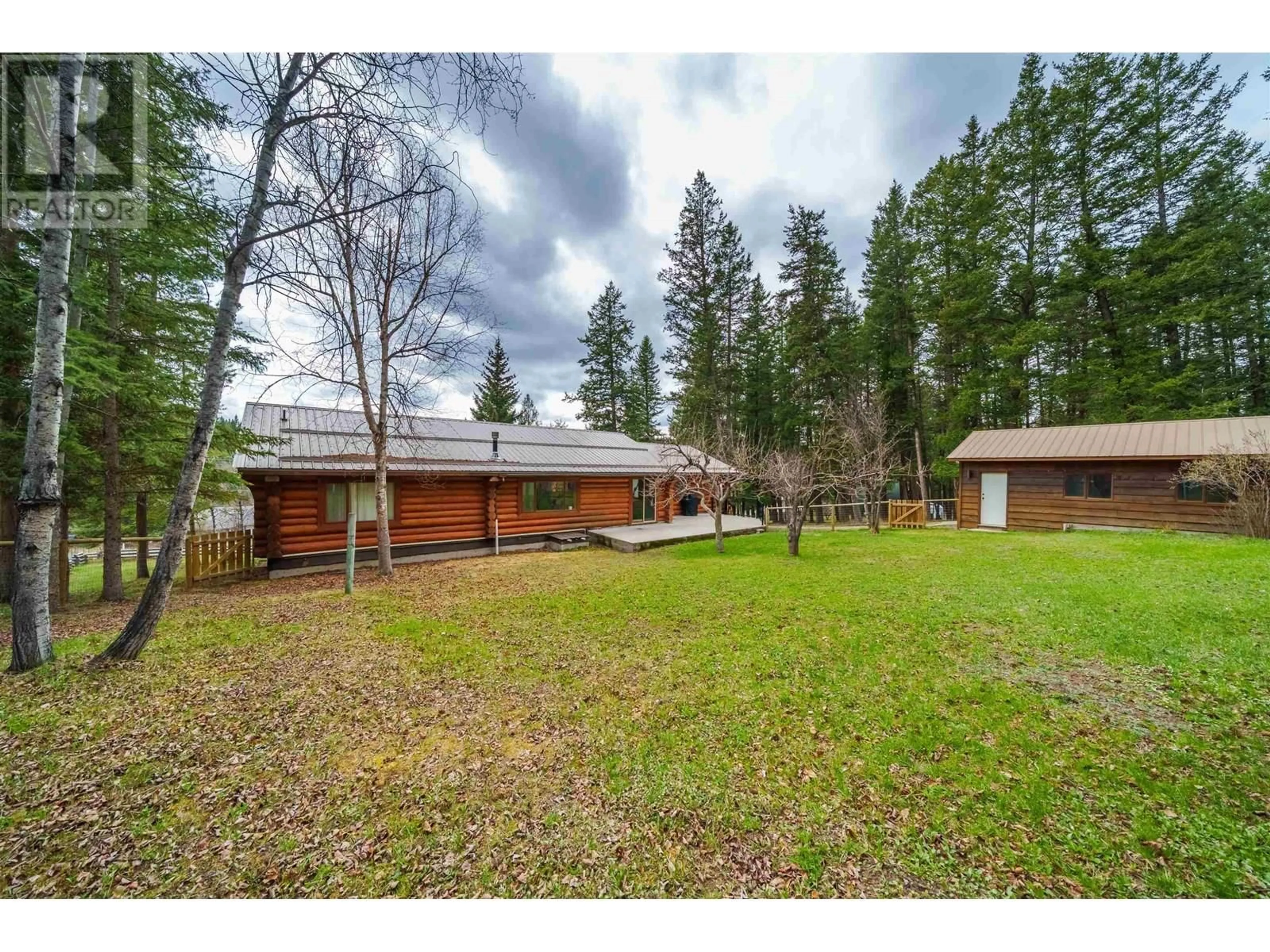 A pic from outside/outdoor area/front of a property/back of a property/a pic from drone, forest/trees view for 5172 KALLUM DRIVE, 108 Mile Ranch British Columbia V0K2Z0