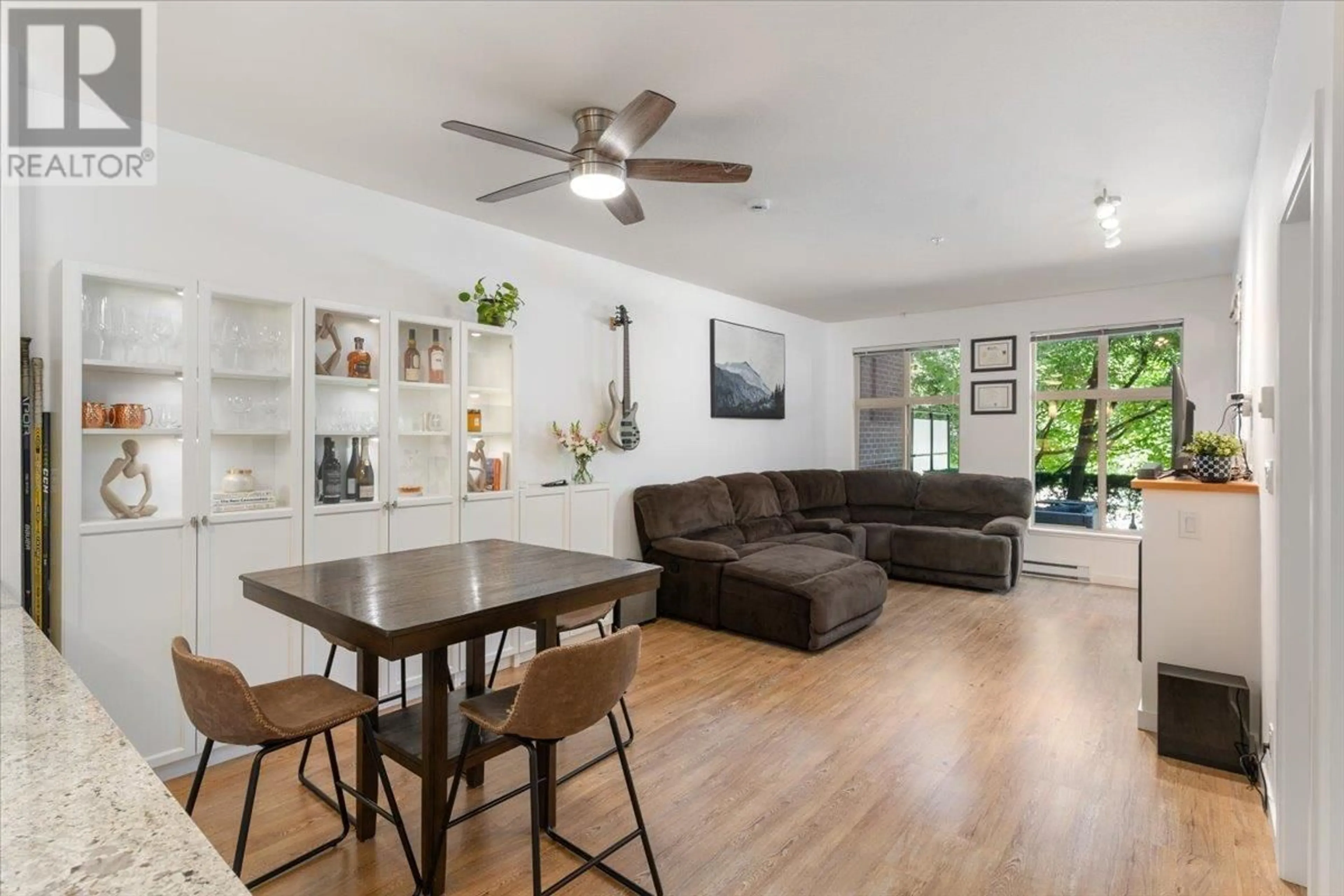 Living room with furniture, wood/laminate floor for 111 - 101 MORRISSEY ROAD, Port Moody British Columbia V3H0E6