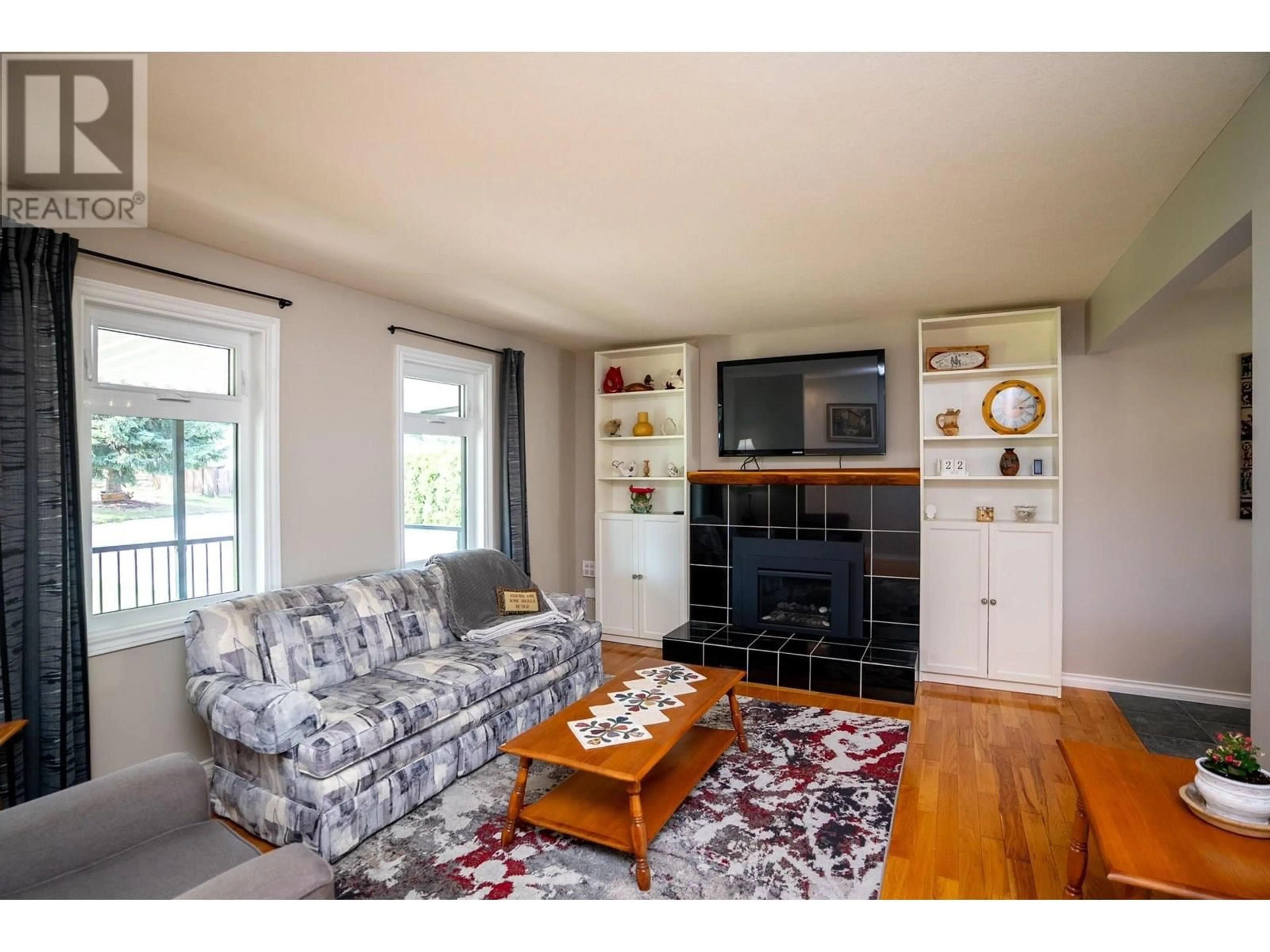 Living room with furniture, wood/laminate floor for 5636 SIMON FRASER AVENUE, Prince George British Columbia V2N2C3