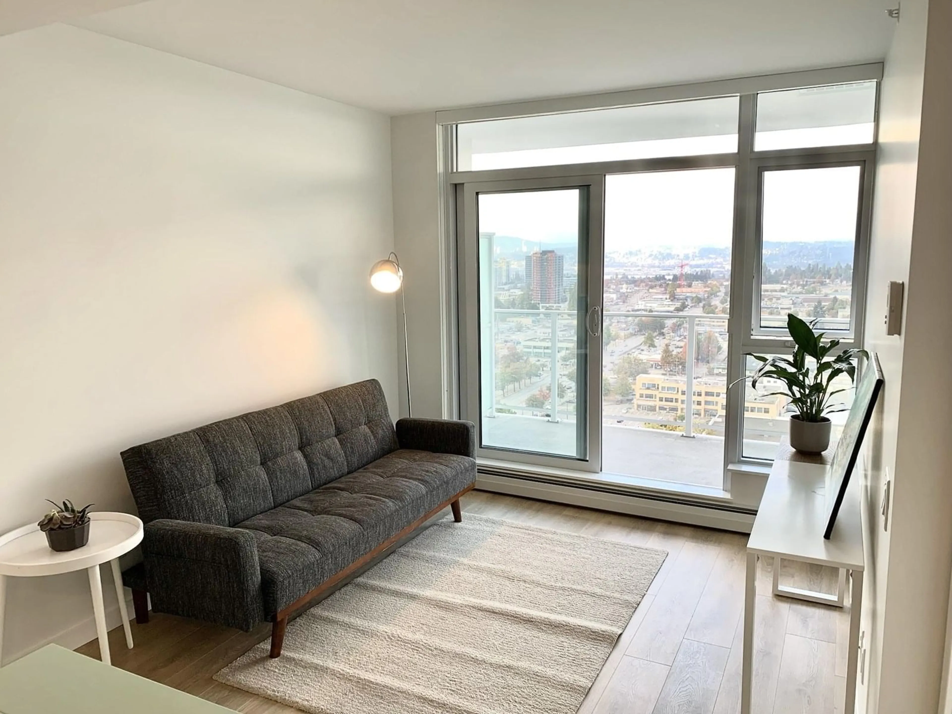 Living room with furniture, wood/laminate floor for 2501 - 13685 102, Surrey British Columbia V3T1N7