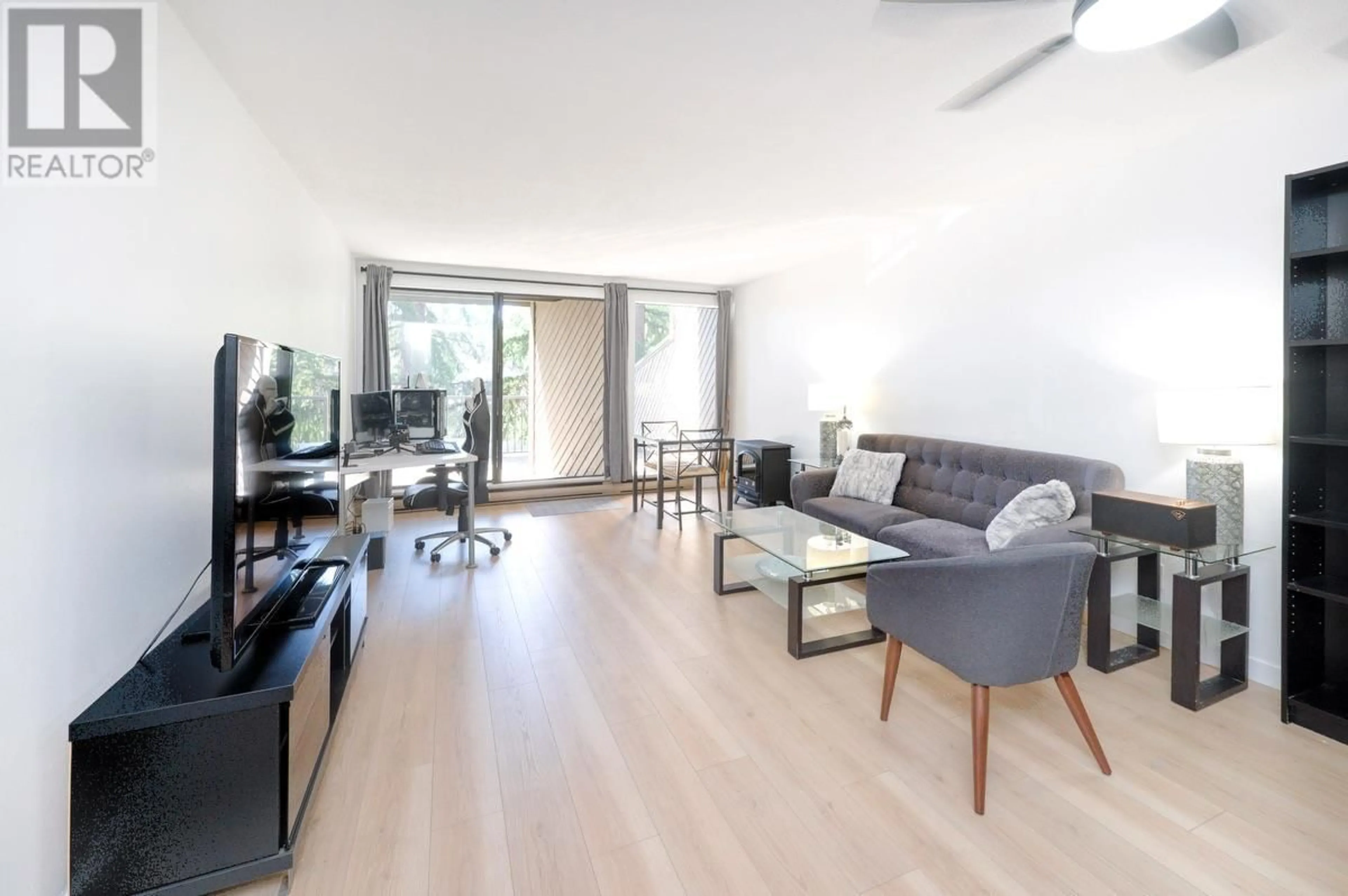 Living room with furniture, wood/laminate floor for 106 - 9300 GLENACRES DRIVE, Richmond British Columbia V7A1Y8