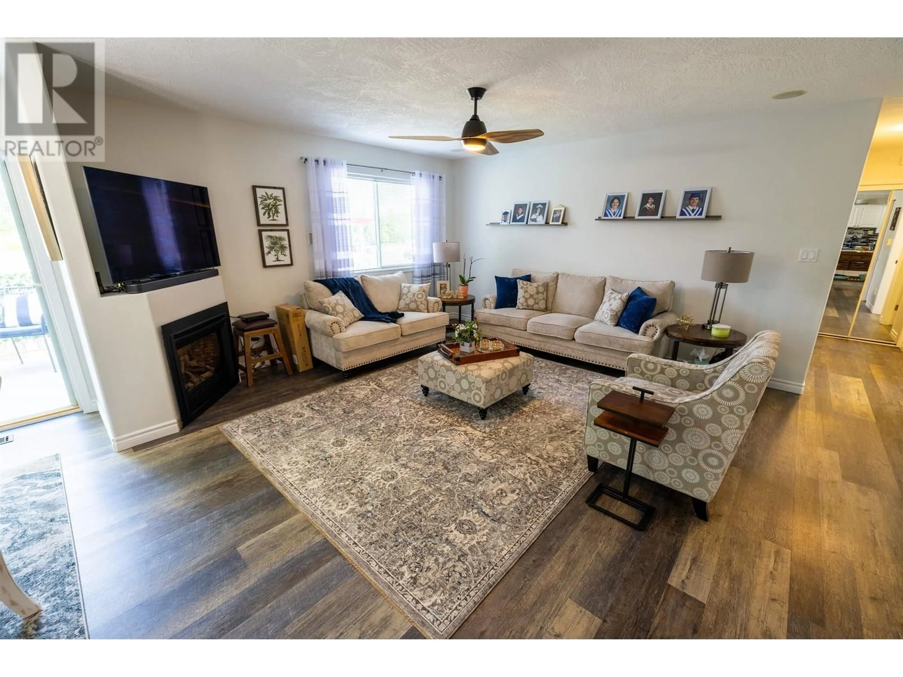 Living room with furniture, wood/laminate floor for 104 - 6807 WESTGATE AVENUE, Prince George British Columbia V2N5T8