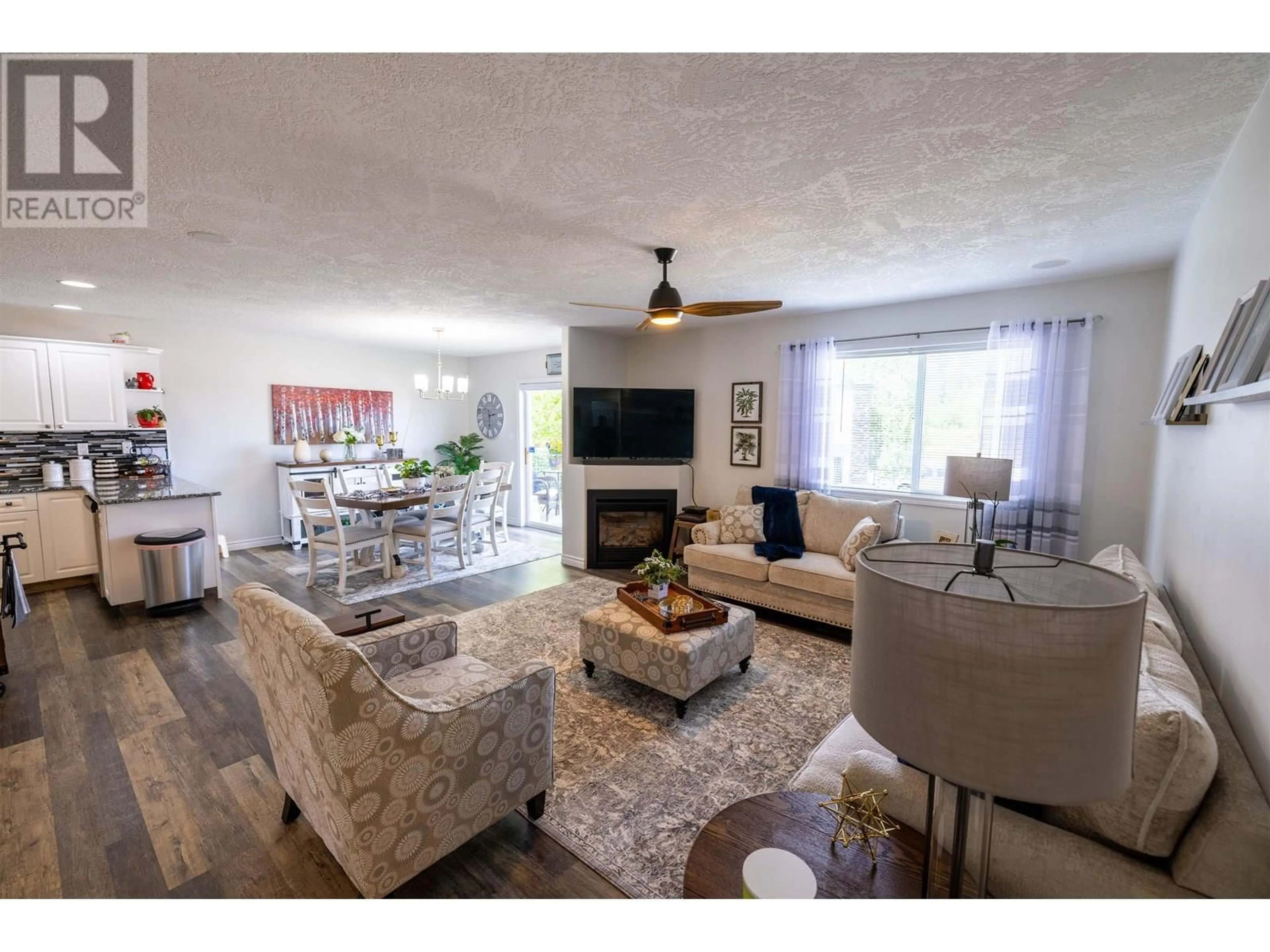 Living room with furniture, wood/laminate floor for 104 - 6807 WESTGATE AVENUE, Prince George British Columbia V2N5T8