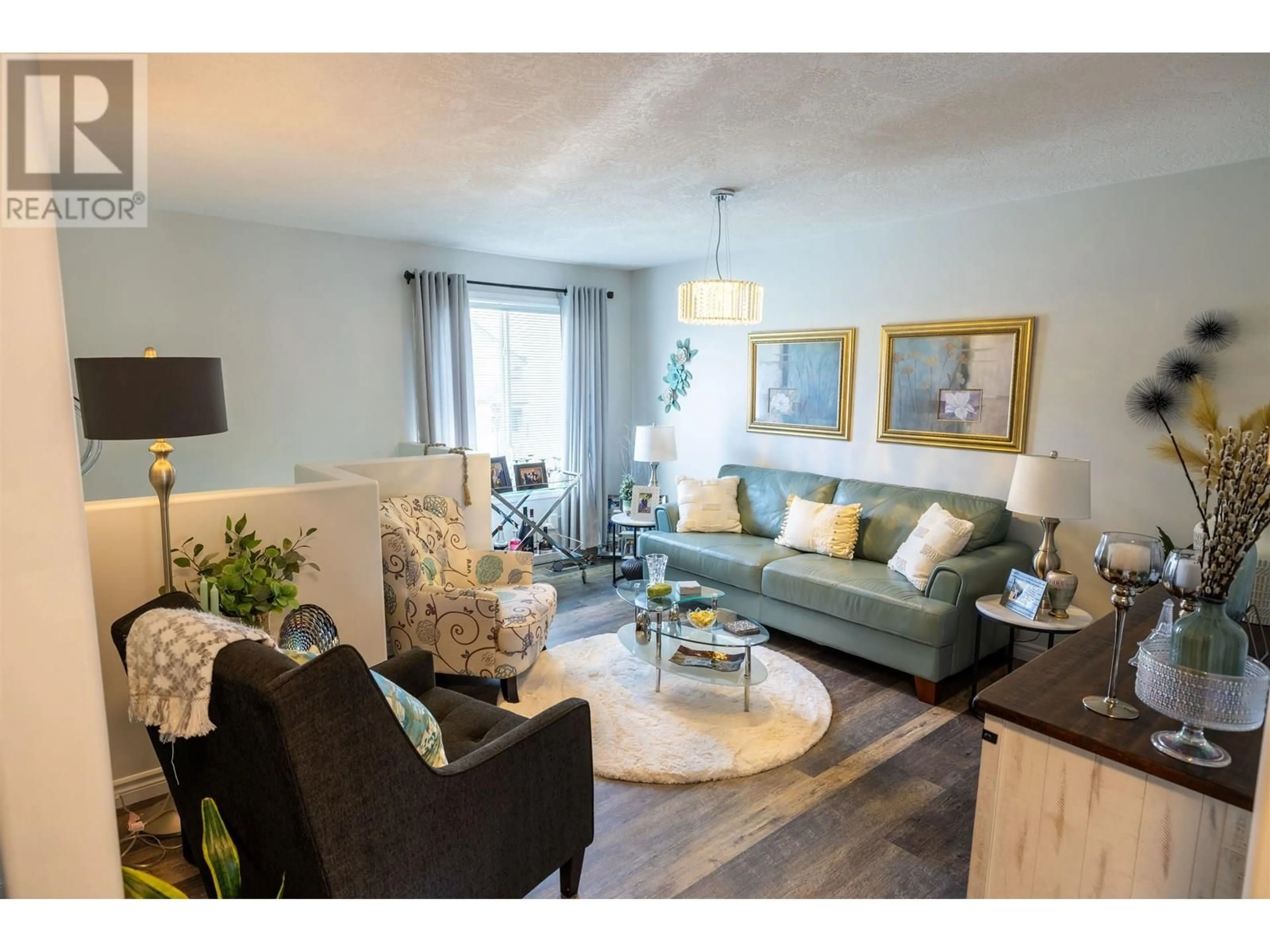 Living room with furniture, wood/laminate floor for 104 - 6807 WESTGATE AVENUE, Prince George British Columbia V2N5T8