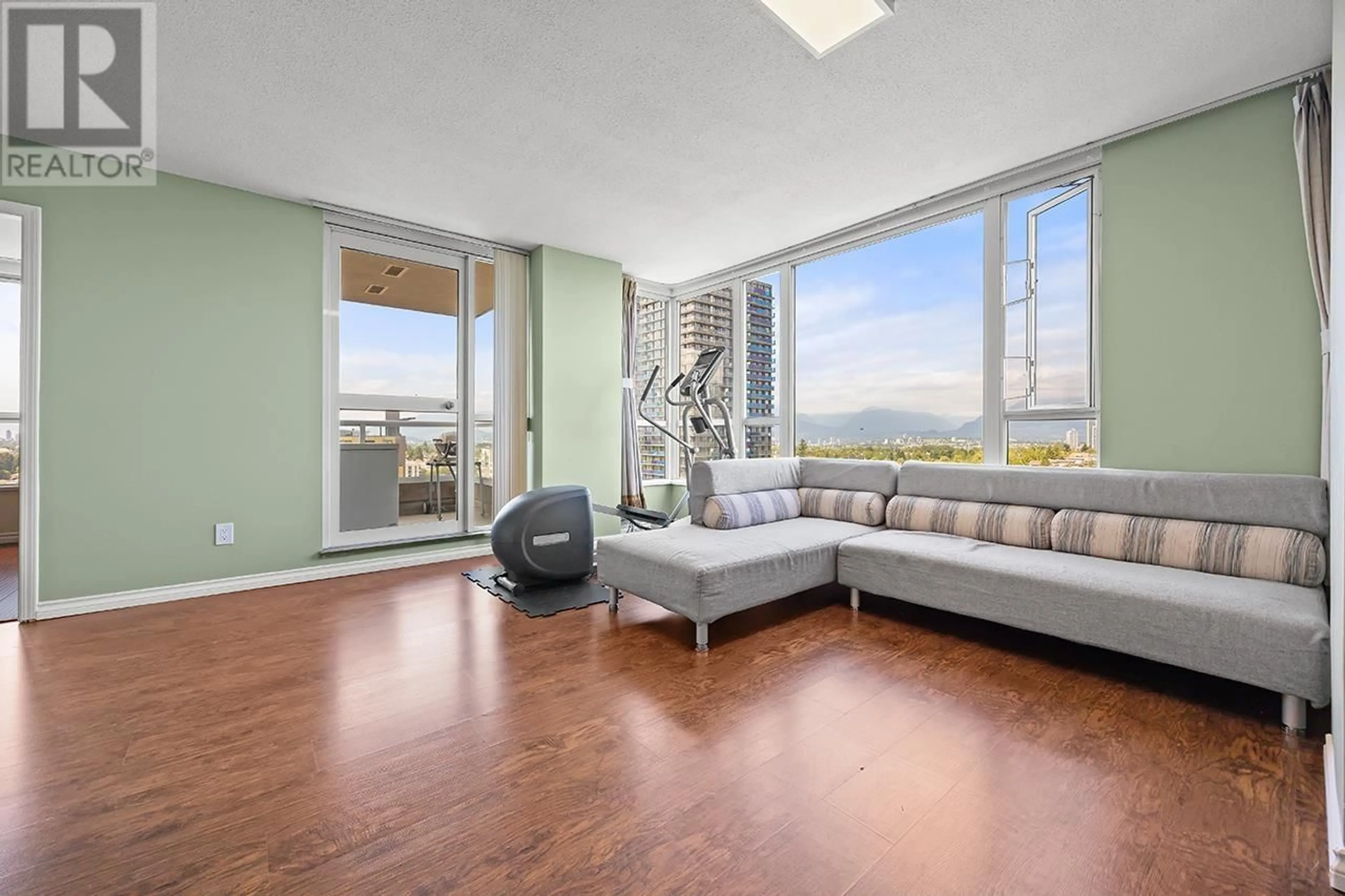 Living room with furniture, wood/laminate floor for 1807 - 5189 GASTON STREET, Vancouver British Columbia V5R6C7