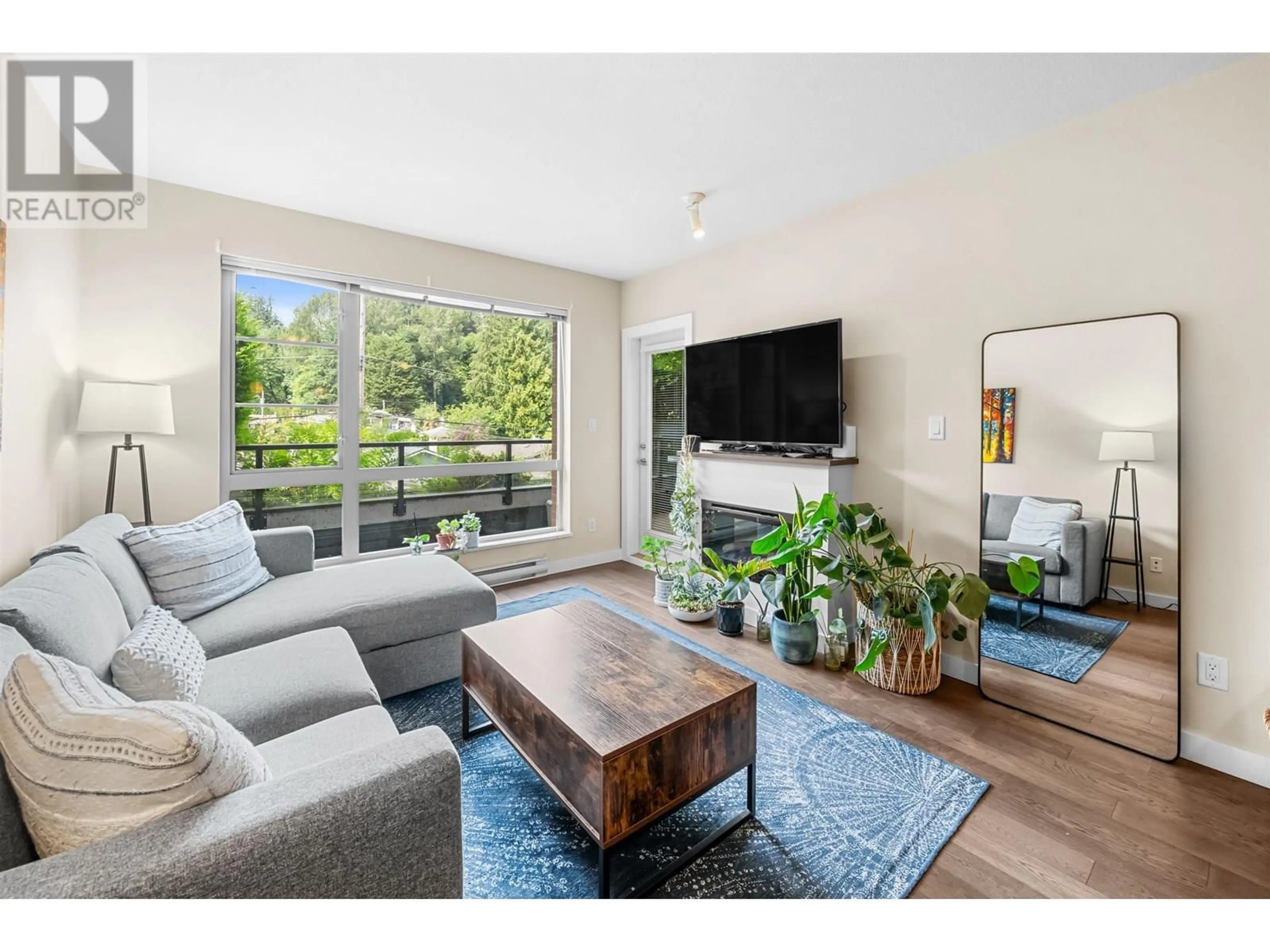 Living room with furniture, wood/laminate floor for 215 - 1330 MARINE DRIVE, North Vancouver British Columbia V7P1T4