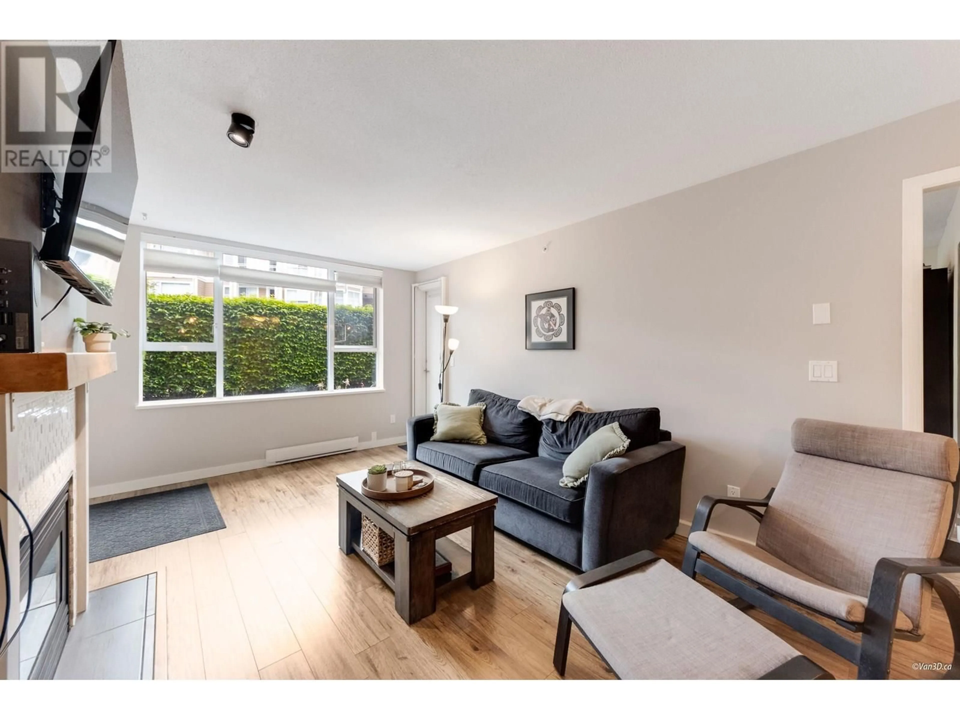 Living room with furniture, wood/laminate floor for 103 - 3608 DEERCREST DRIVE, North Vancouver British Columbia V7G2S8