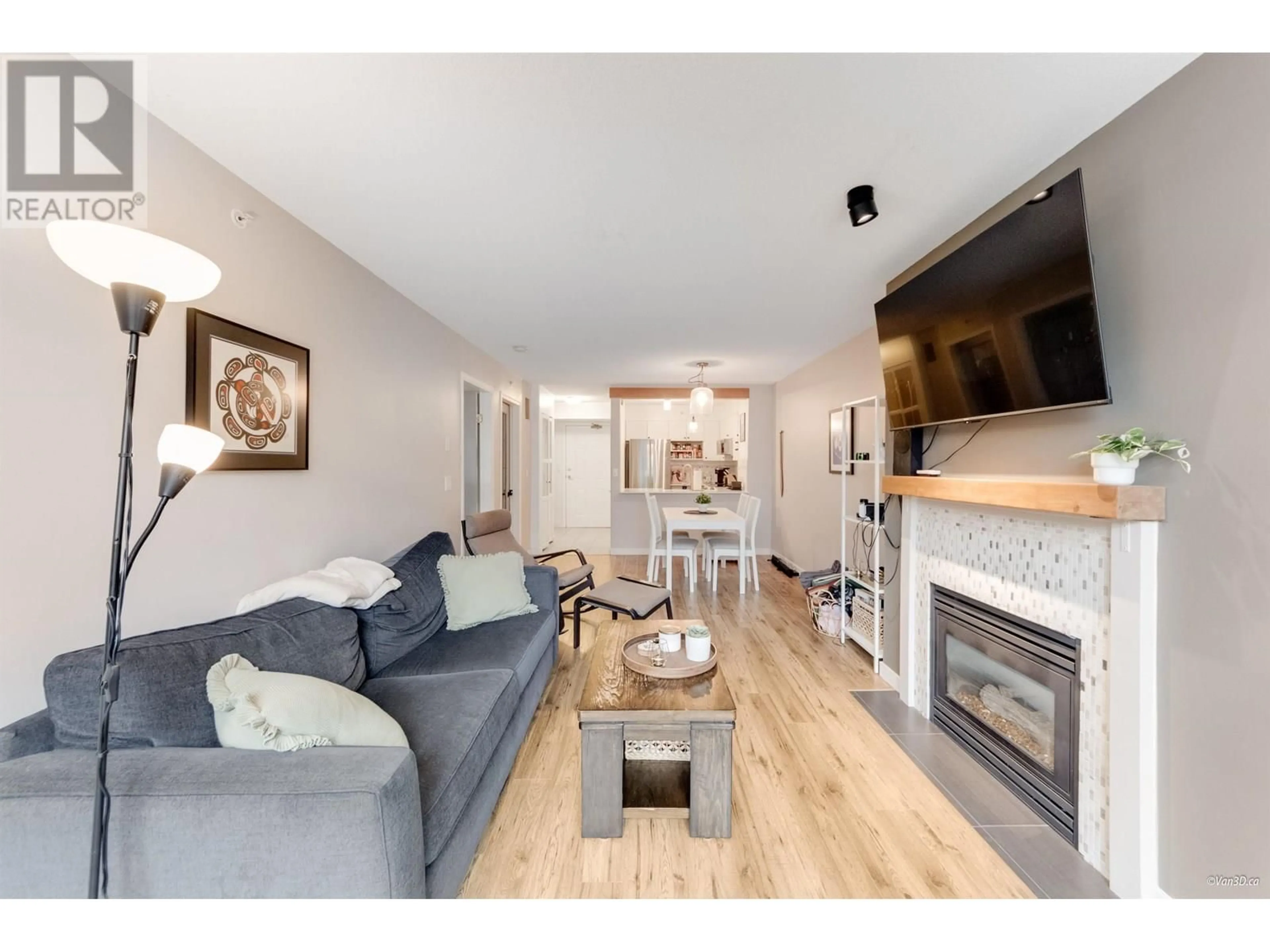 Living room with furniture, wood/laminate floor for 103 - 3608 DEERCREST DRIVE, North Vancouver British Columbia V7G2S8