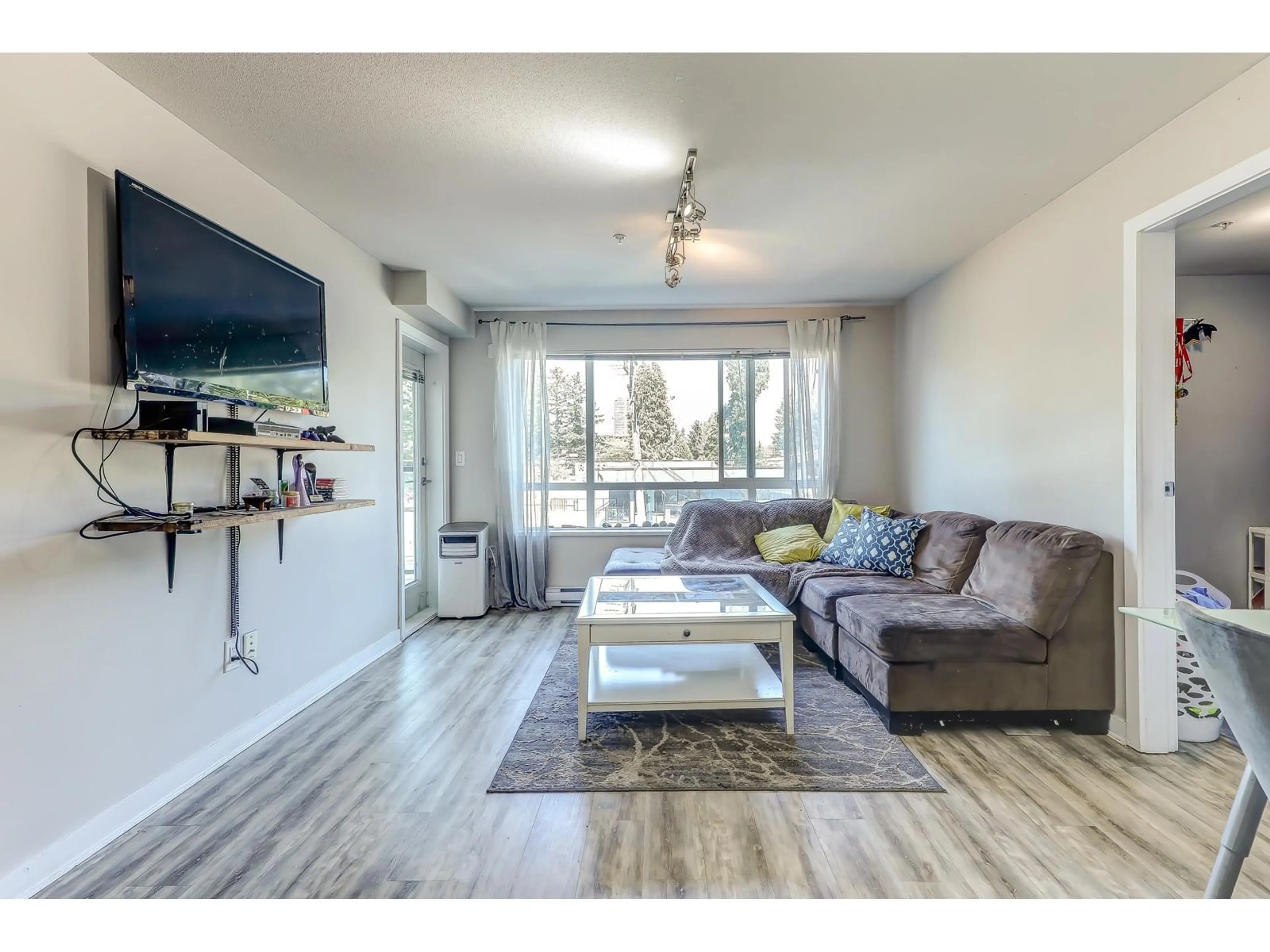 Living room with furniture, wood/laminate floor for 211 - 7511 120, Delta British Columbia V4C0C1