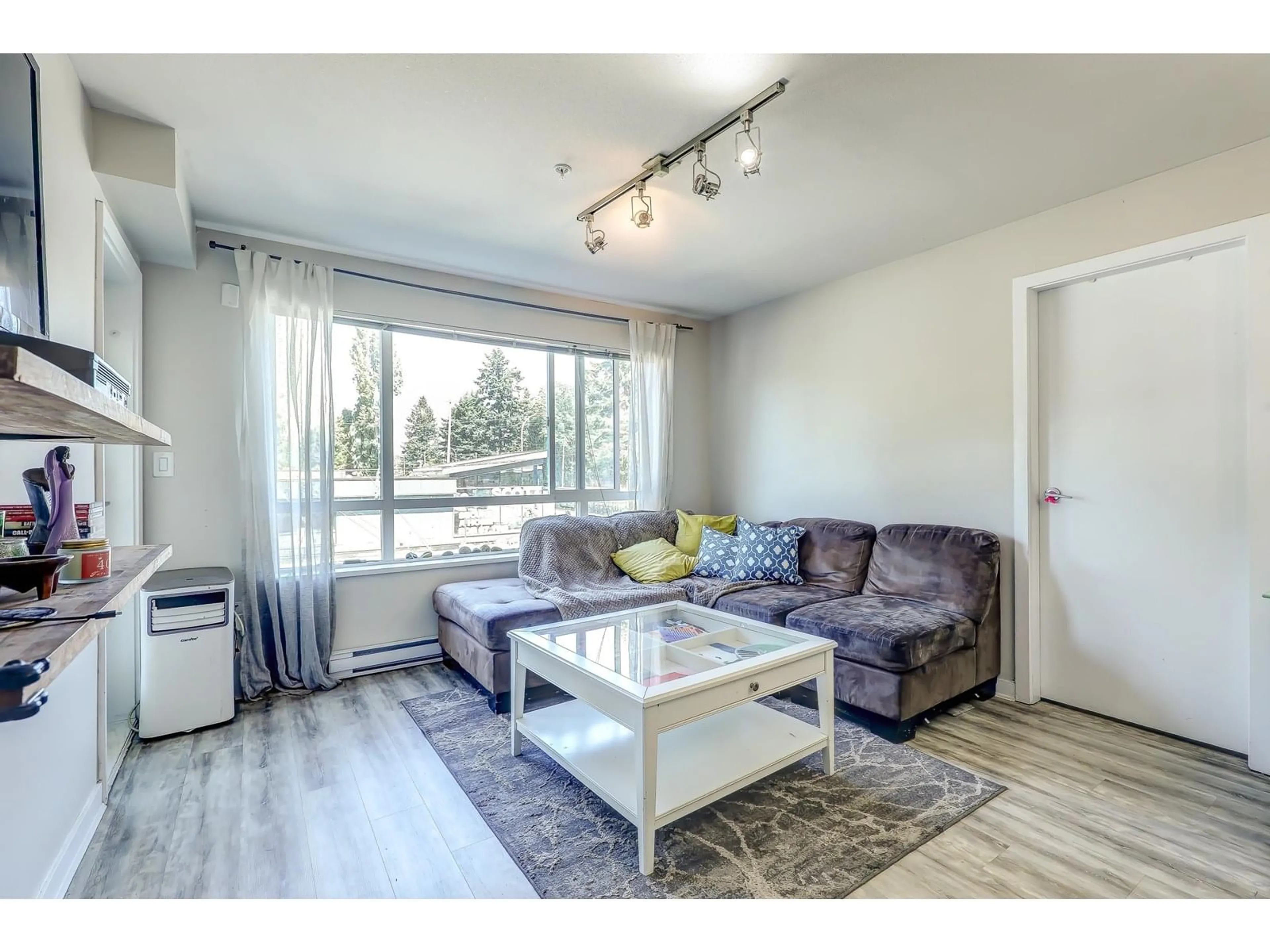Living room with furniture, wood/laminate floor for 211 - 7511 120, Delta British Columbia V4C0C1