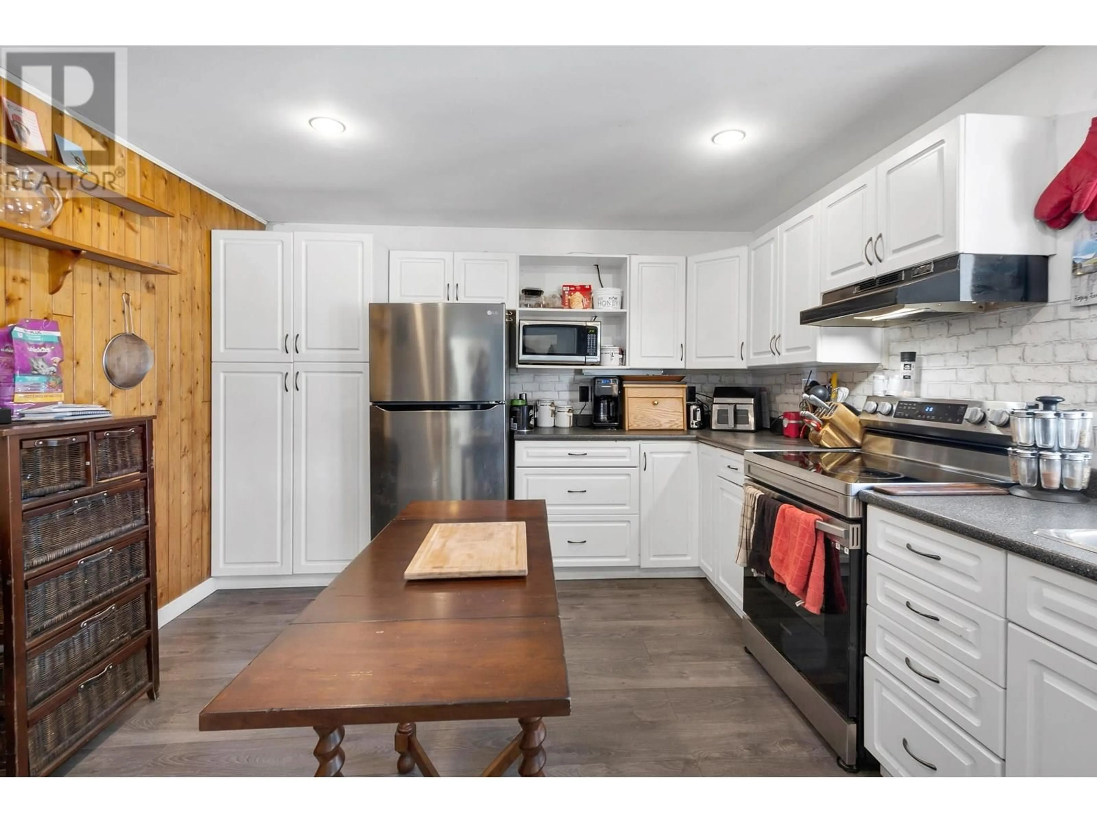 Open concept kitchen, wood/laminate floor for 7545 POOLEY ROAD, Prince George British Columbia V2N5W4
