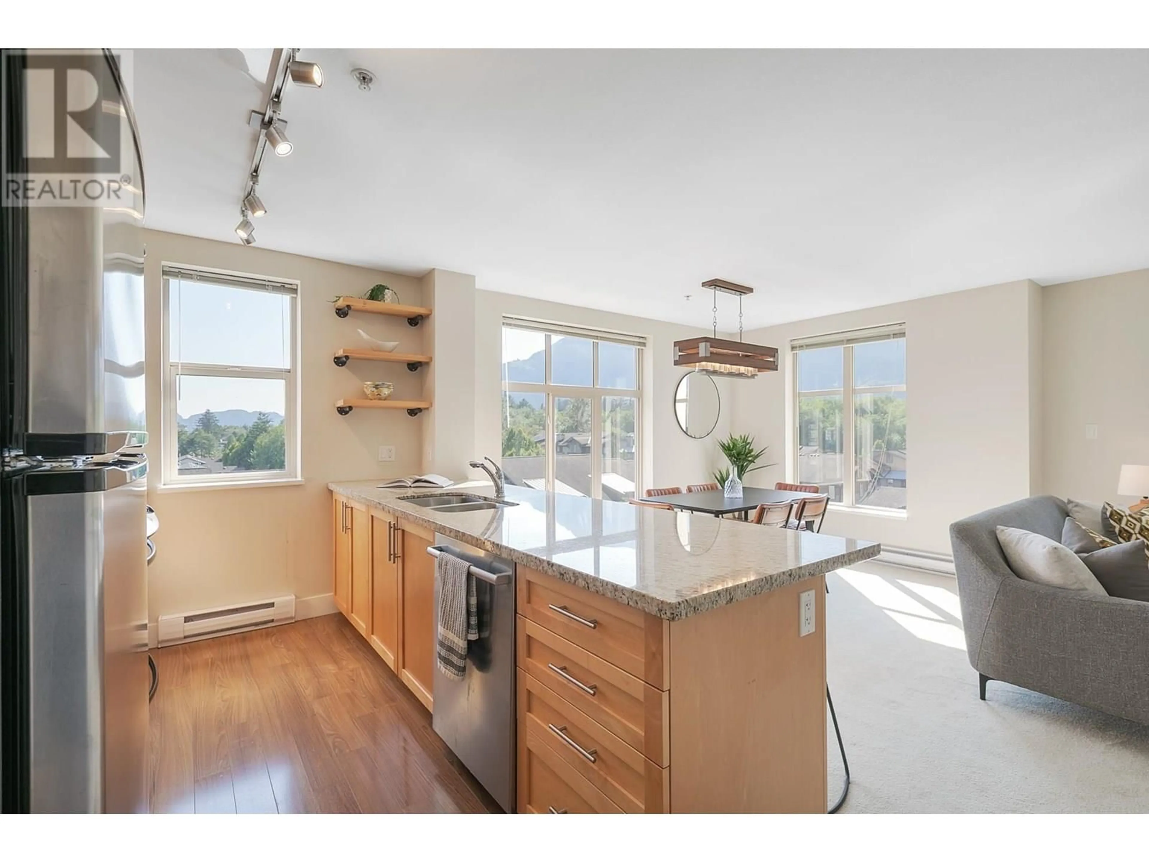 Open concept kitchen, wood/laminate floor for 401 - 1211 VILLAGE GREEN WAY, Squamish British Columbia V8B0R7